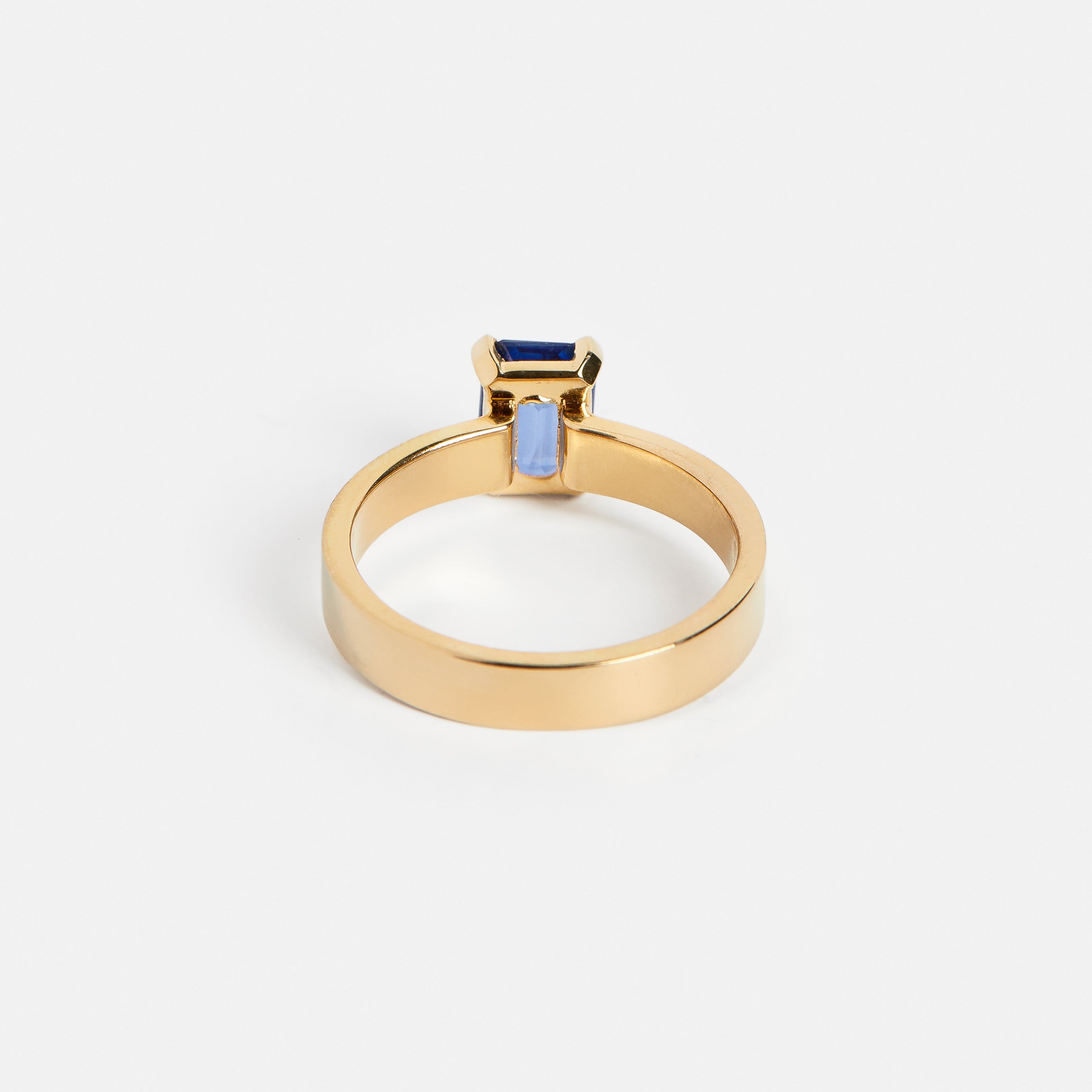 Cool Simple Prong Engagement Ring with 1ct navy blue emerald-cut sapphire in 14 karat yellow gold by SHW famous fine jewelry stores in NYC