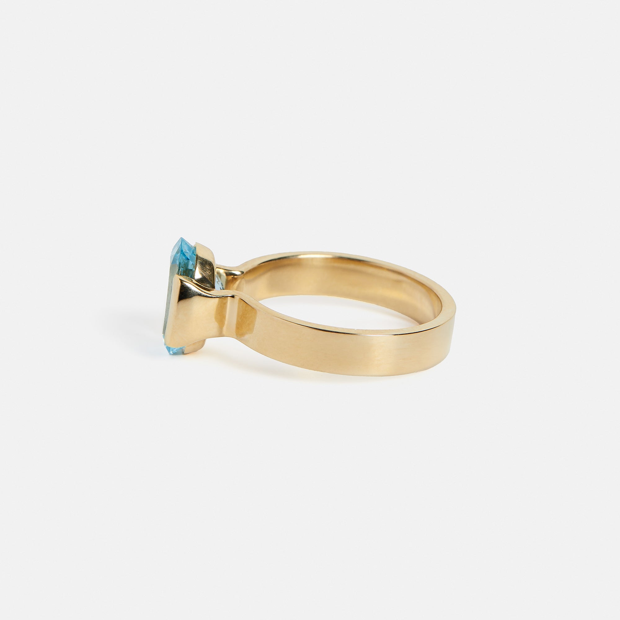 Unique Partially Bezel Set Tabs Engagement Ring with oval aquamarine in 14k yellow gold by SHW best fine jewelry store in NYC near me
