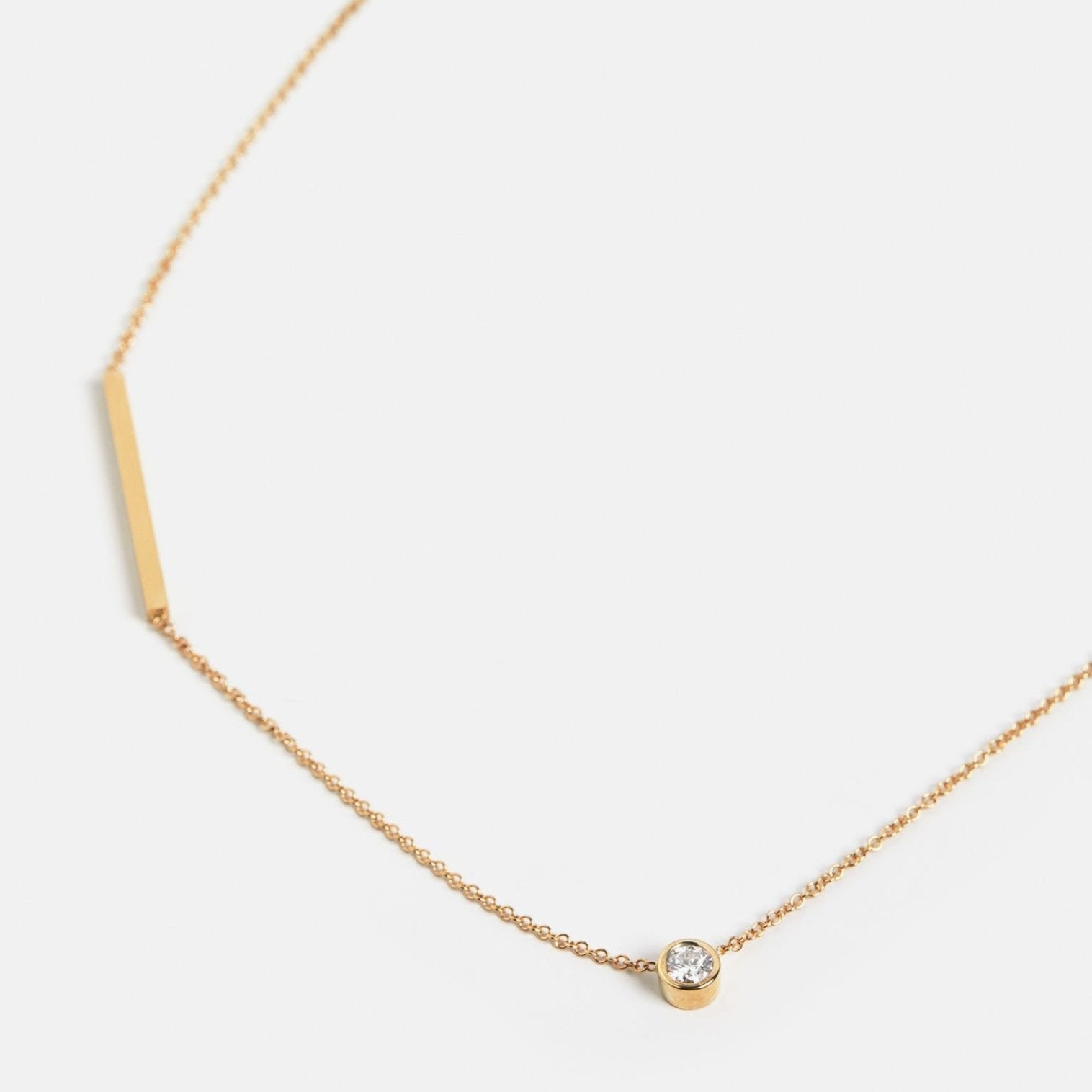 Cool necklace with delicate chain and asymmetrical lab created white diamond in 14 karat gold by SHW best fine jewelry store in NYC
