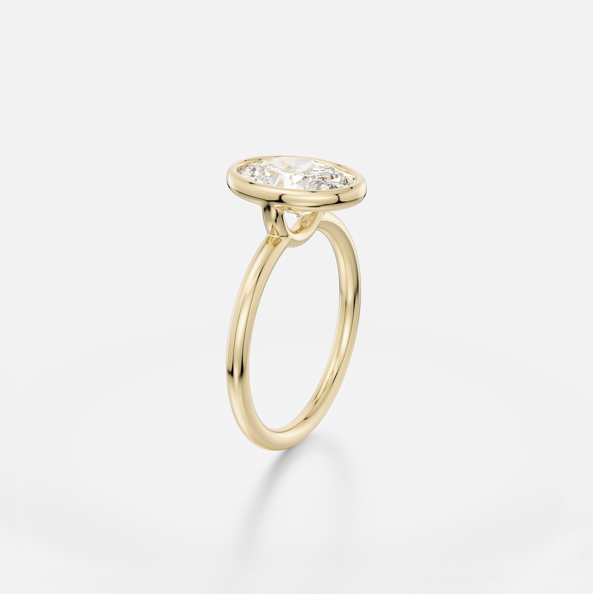 Delicate round profile band engagement ring with 2ct oval diamond in thin bezel setting