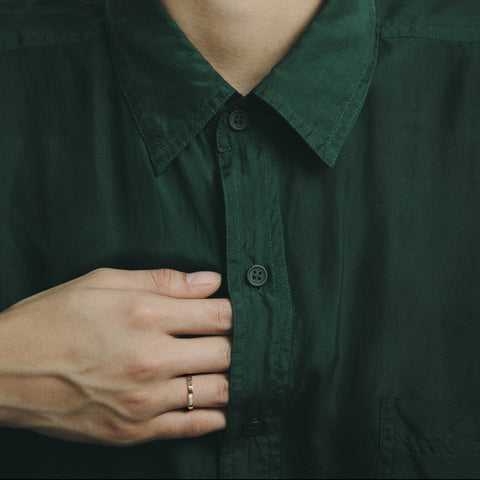 Modern 3mm wedding band with horizontal baguette diamonds shown worn in natural light