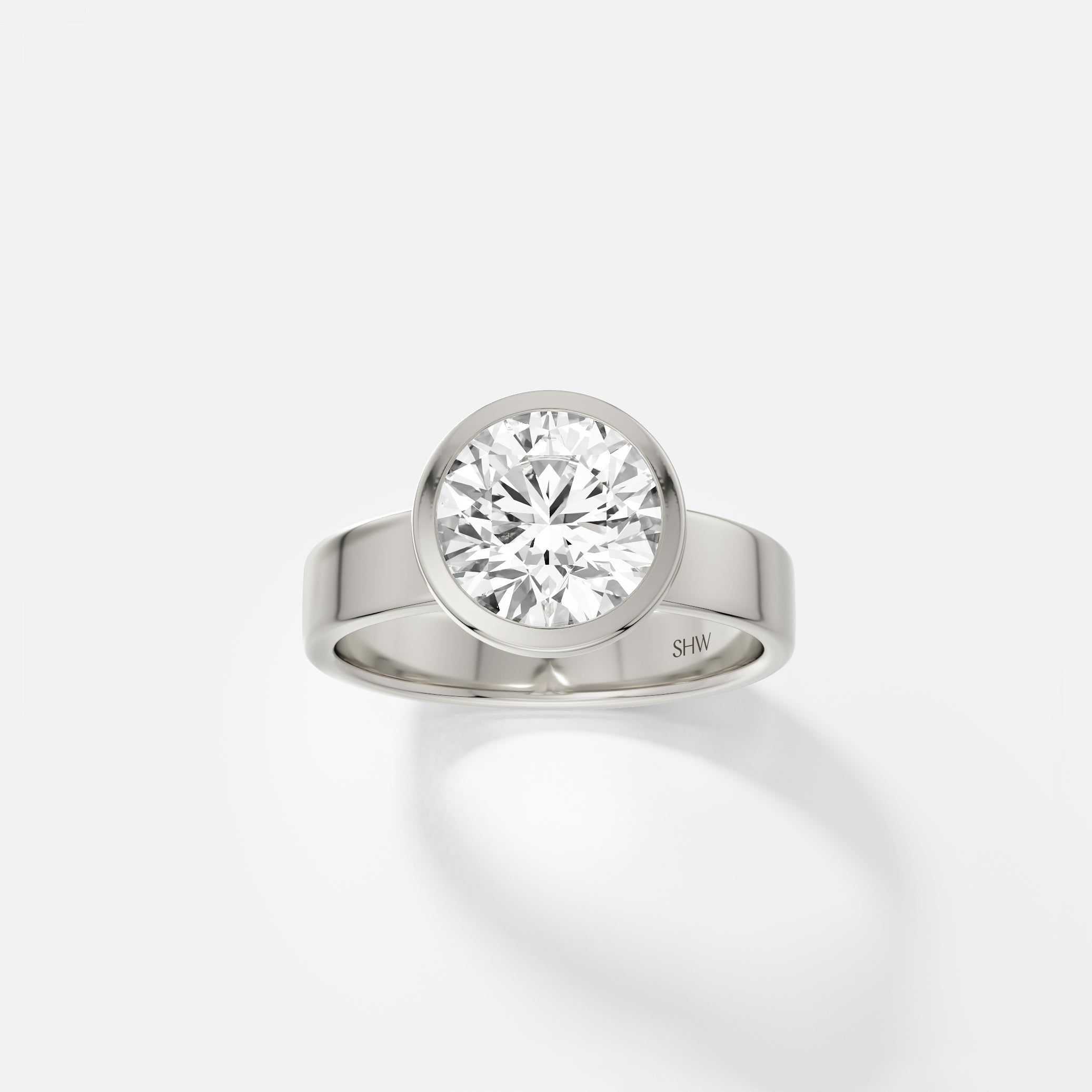 14k white gold wide flat band engagement ring with 2.25 carat round diamond in thin bezel setting