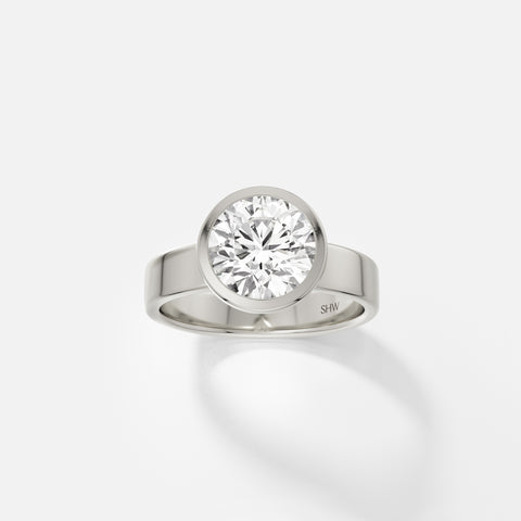 14k white gold wide flat band engagement ring with 2.25 carat round diamond in thin bezel setting