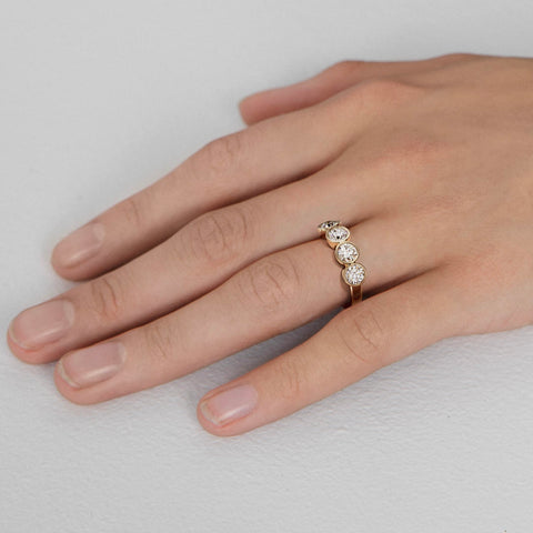 Minimal diamond band with spaced round diamonds shown worn in natural light