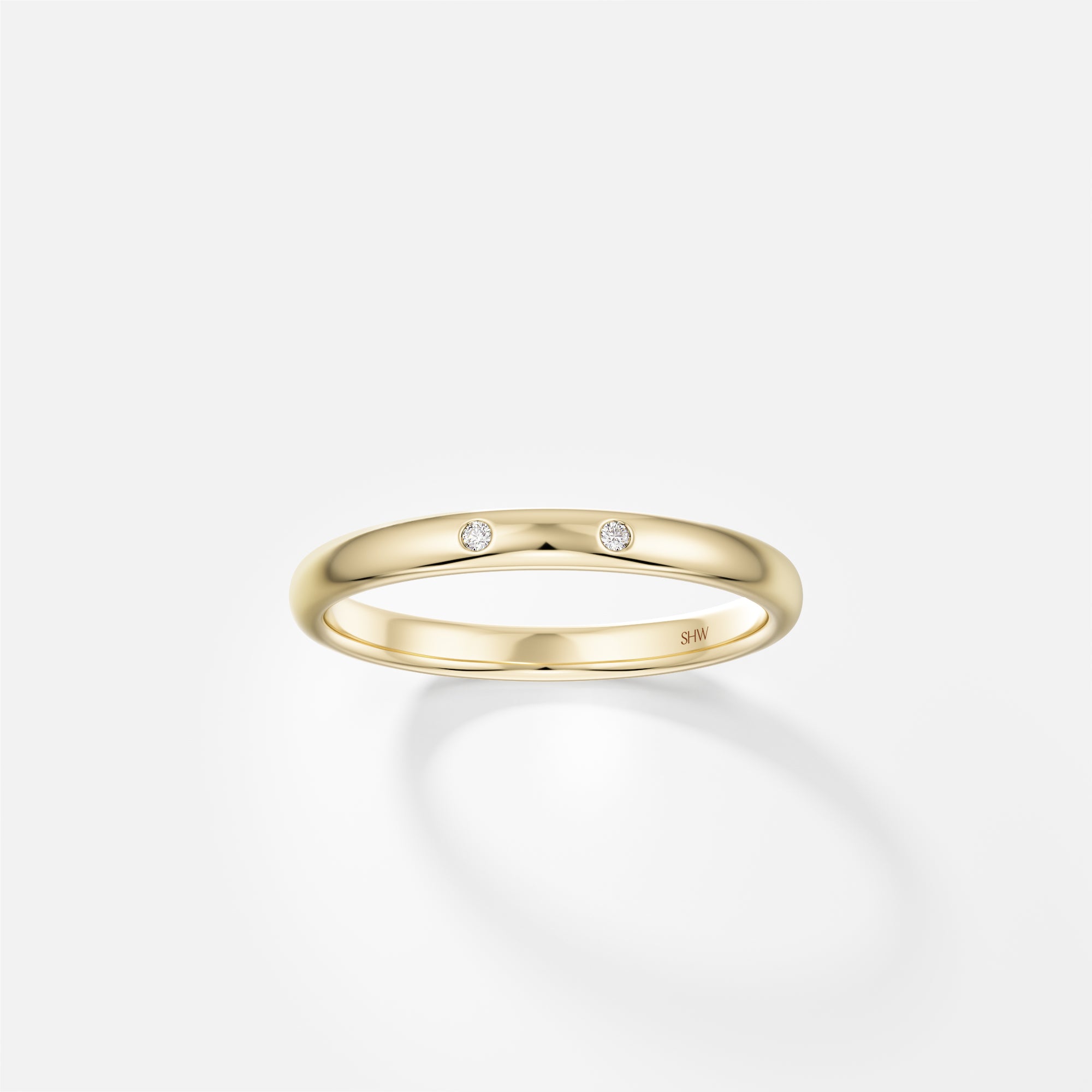 14k yellow gold 2mm domed wedding band with two small round brilliant diamonds