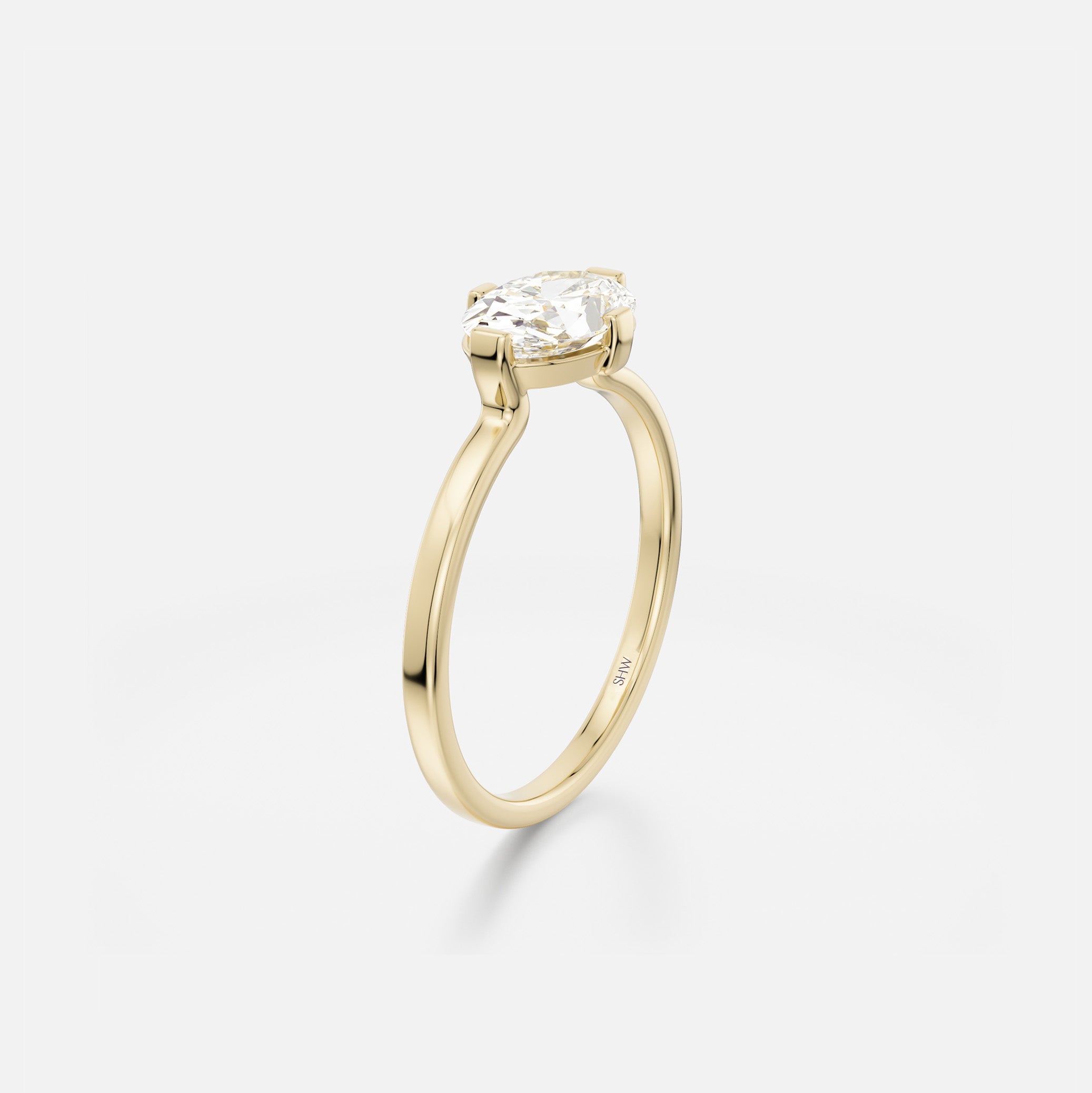 Side angle of 1.00 carat oval diamond engagement ring with open setting and flat band