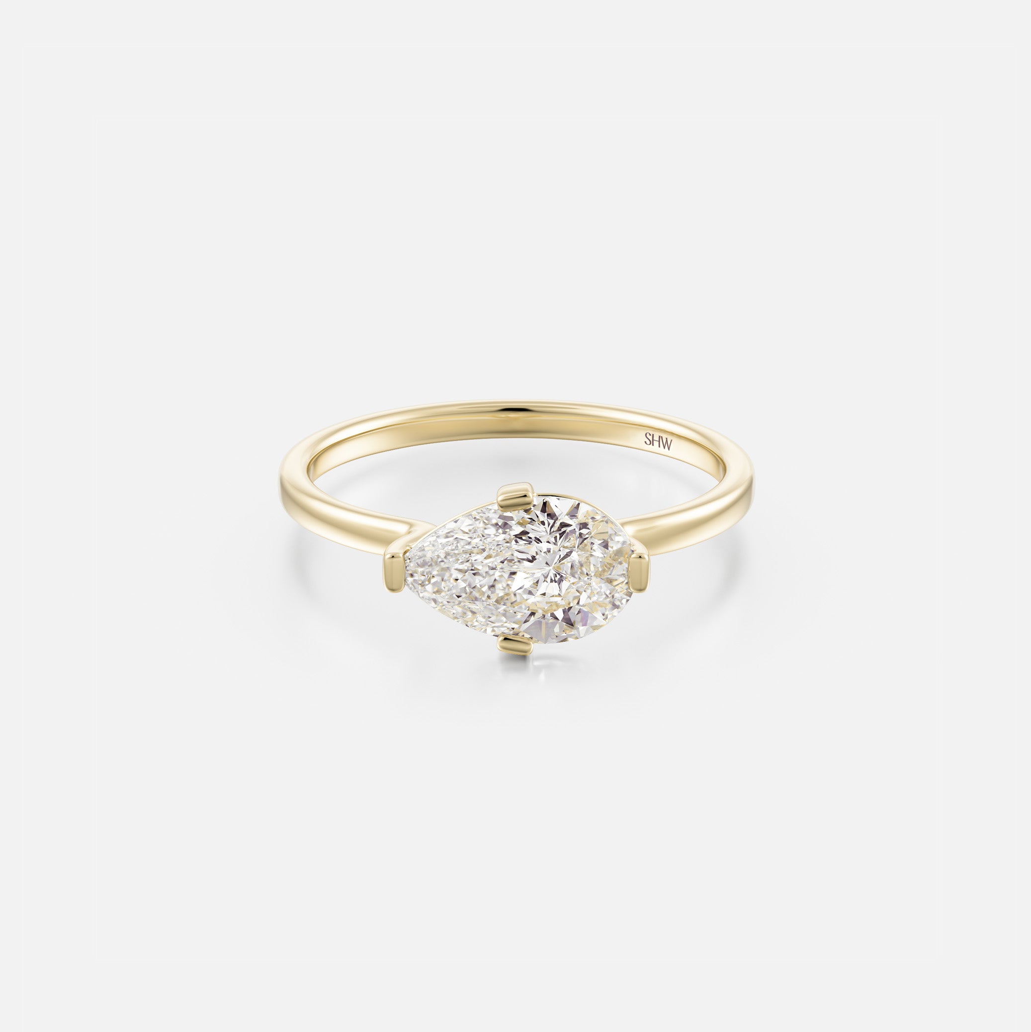 14k yellow gold thin flat band engagement ring with east-west pear diamond