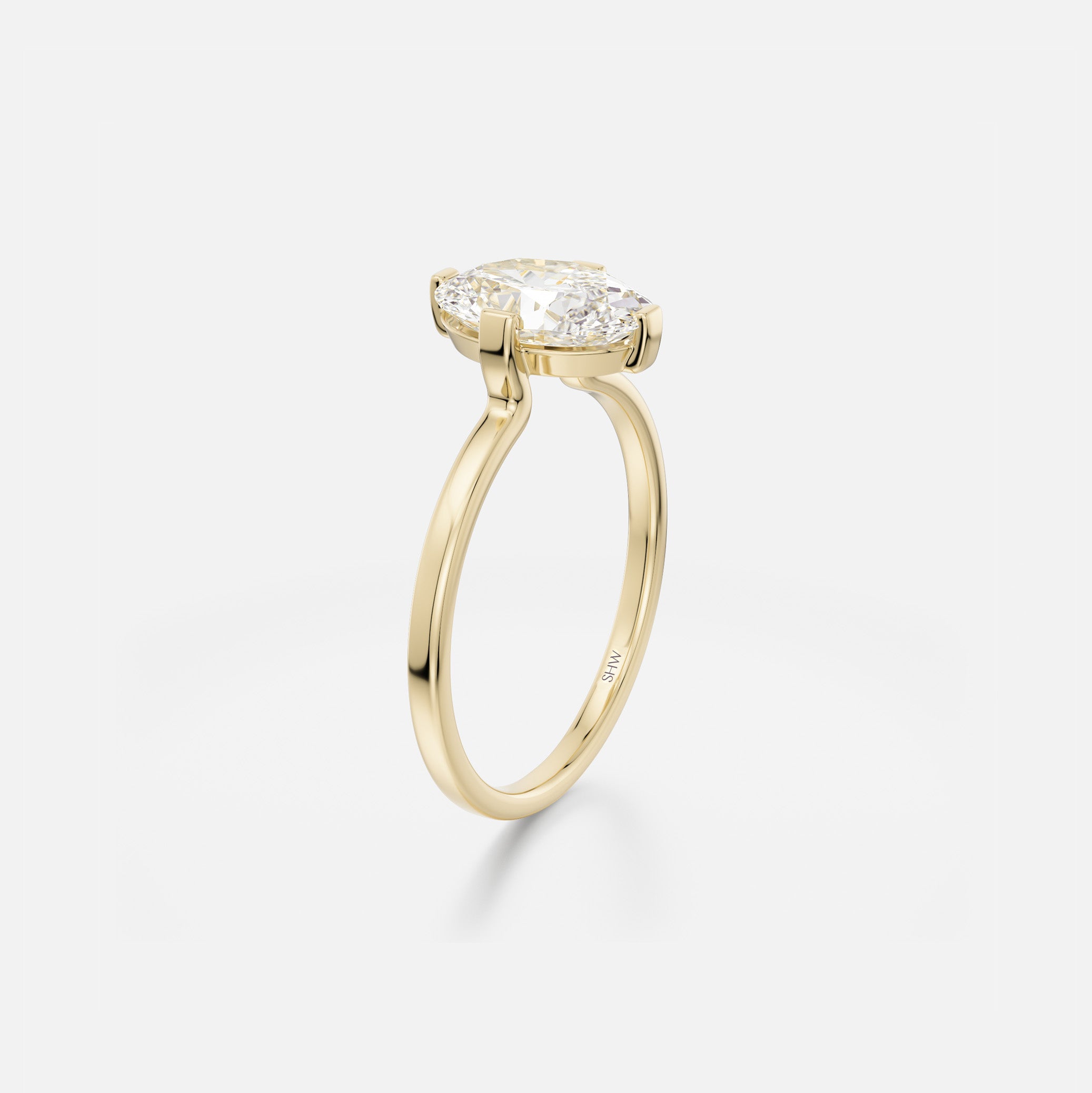 Delicate flat profile engagement ring with open setting and oval diamond