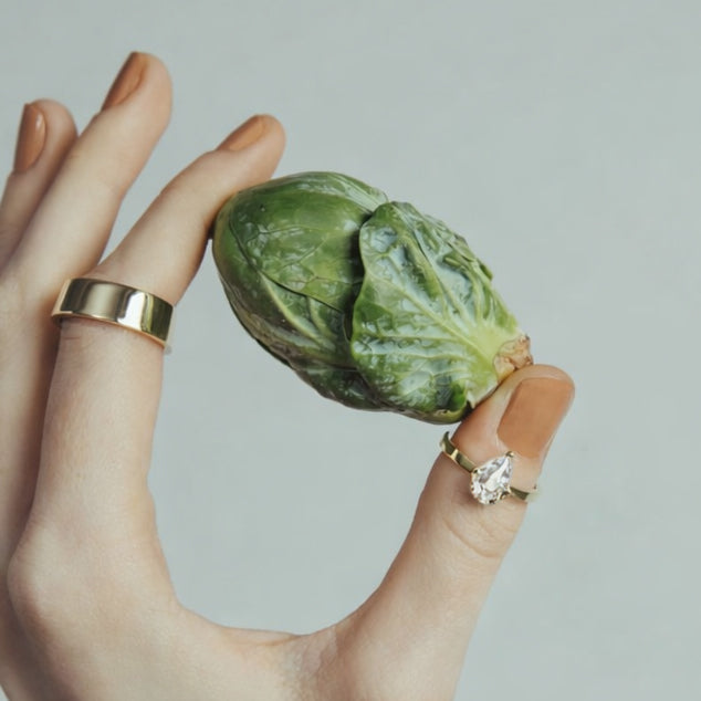 1.30 carat pear-cut diamond engagement ring in minimalist three-prong setting worn on hand