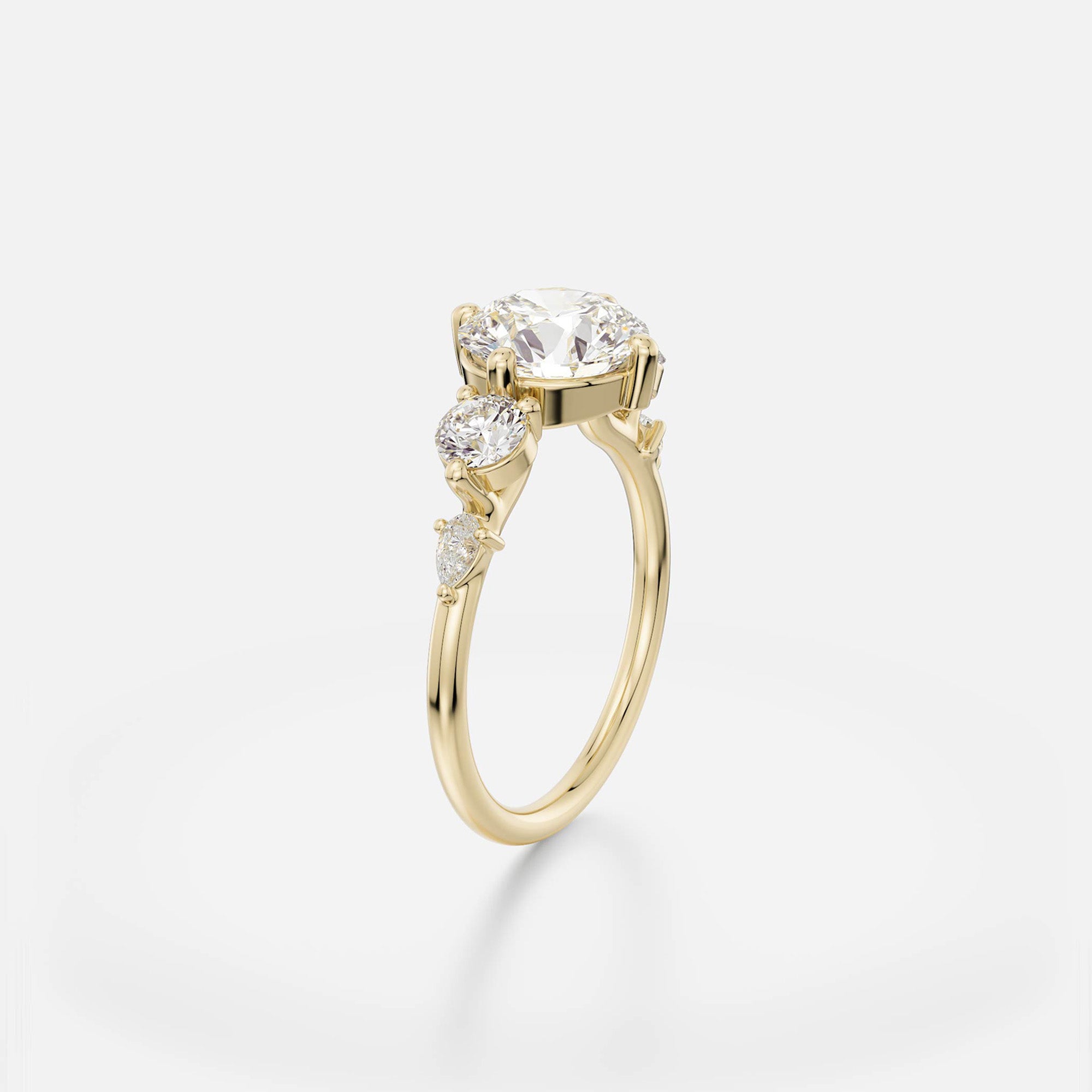 2.50 carat round brilliant diamond engagement ring with pear and round side stones in five stone cluster prong setting