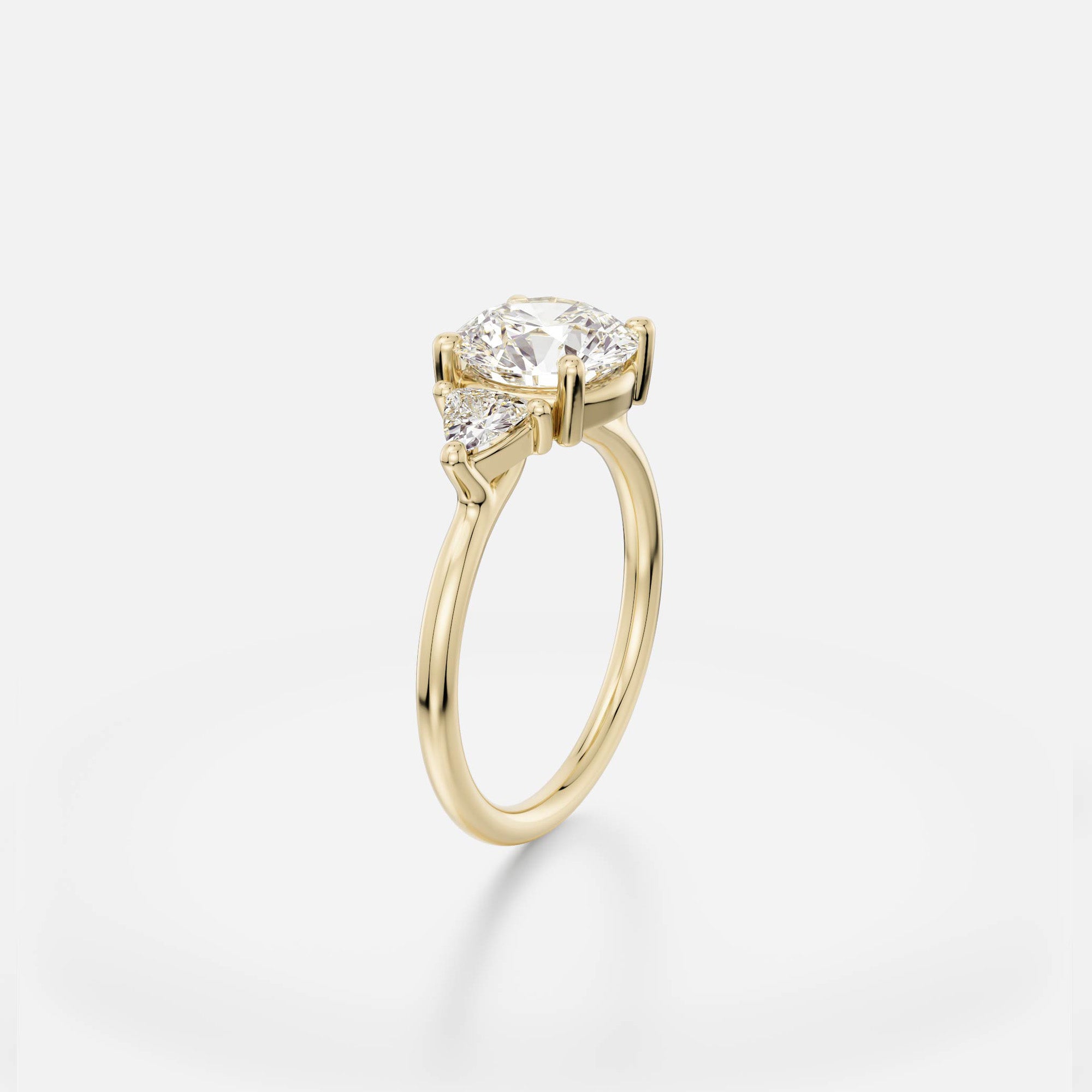 2.00 carat round brilliant diamond engagement ring with trillion side stones in delicate prong cluster setting