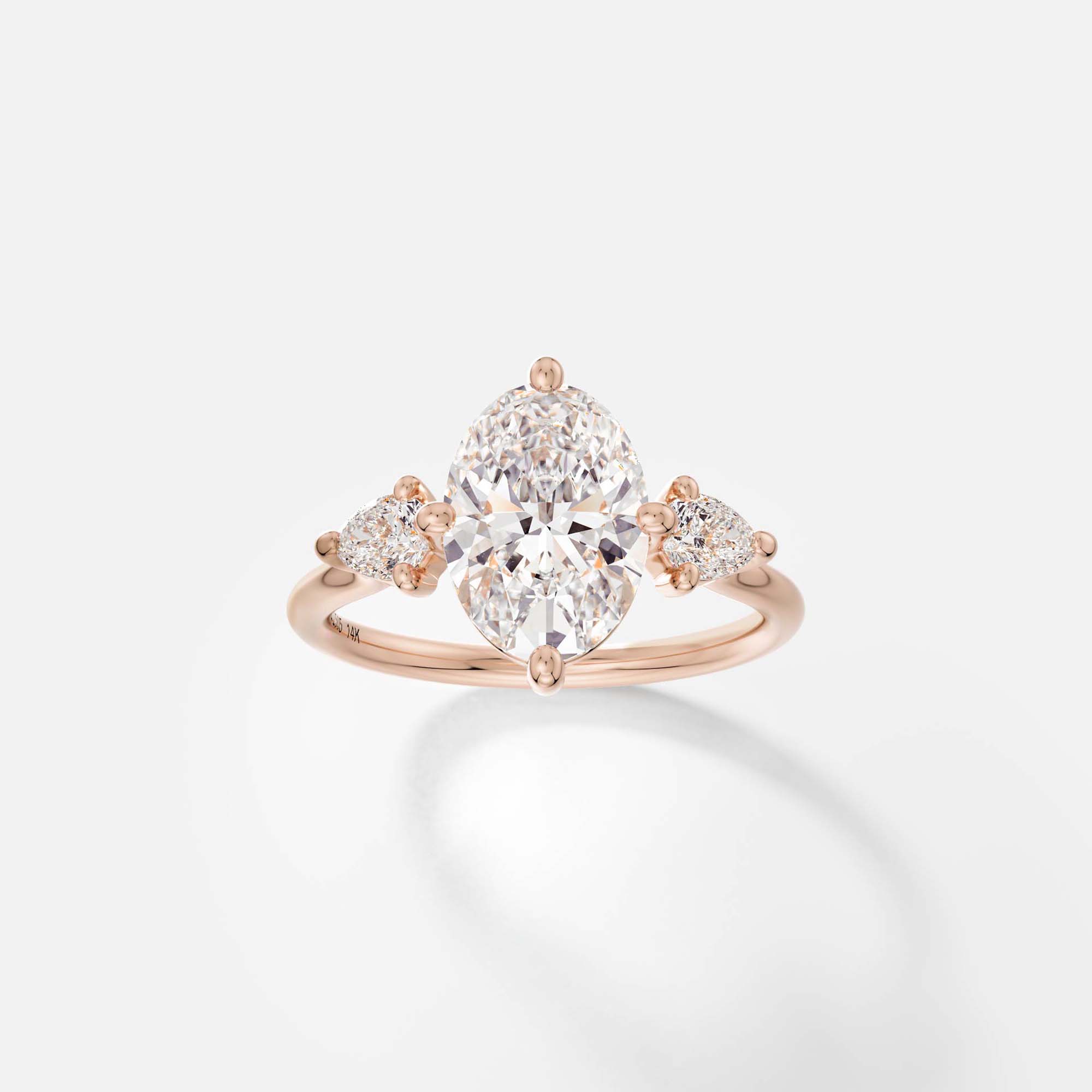 Delicate Three-Stone Engagement Ring Prong-Set North South Oval Pear laboratory Canadian diamond in 14k 18k SHW coolest fine jewelry store