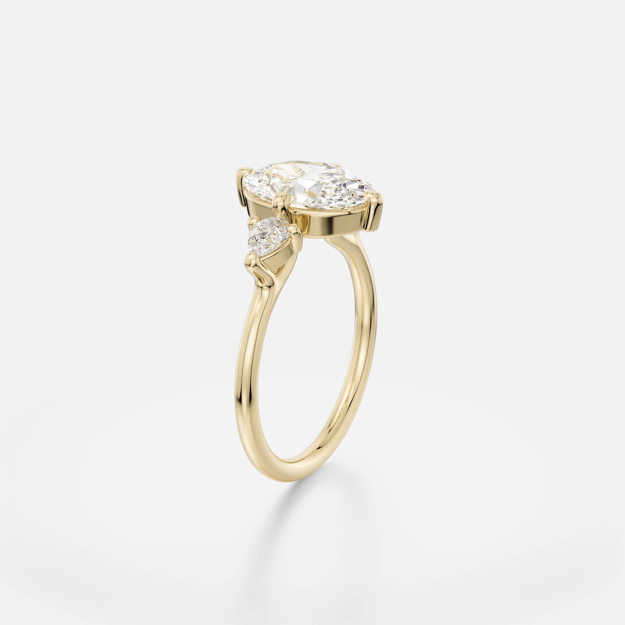 2 ct oval diamond engagement ring with pear accent stones in compass prong setting on thin round band open setting