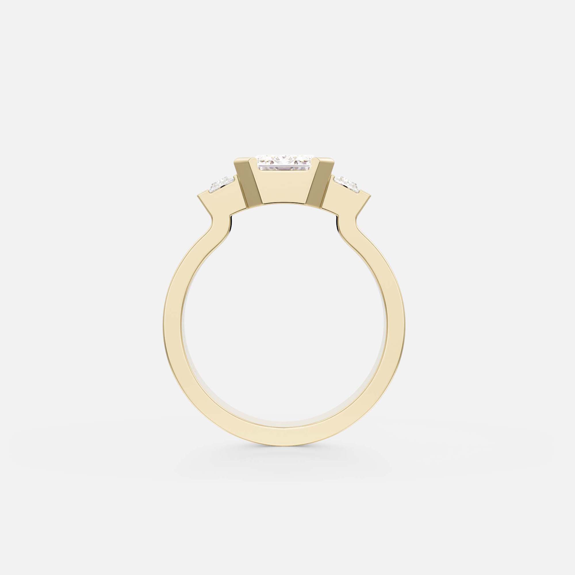 side profile of emerald-cut diamond three stone ring with baguette accents in partial bezel on structured flat band
