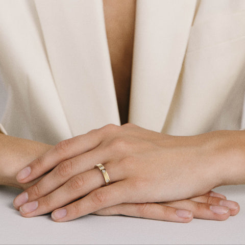 Wedding band set with triangular trillion-cut diamonds shown worn in natural light