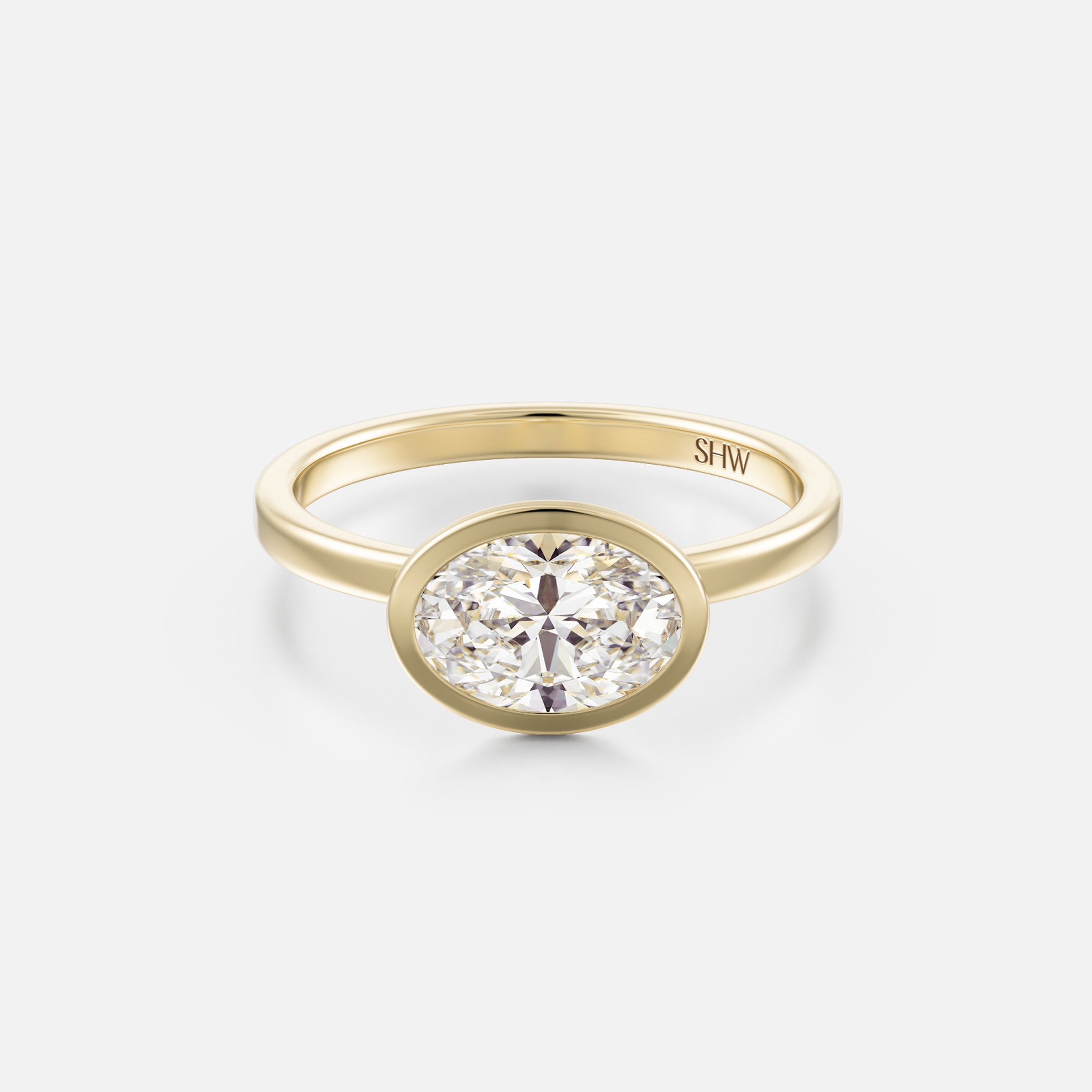 14k yellow gold thin flat band engagement ring with 1.50 carat east-west oval brilliant-cut diamond in bezel setting