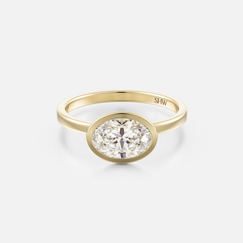 14k yellow gold thin flat band engagement ring with 1.50 carat east-west oval brilliant-cut diamond in bezel setting