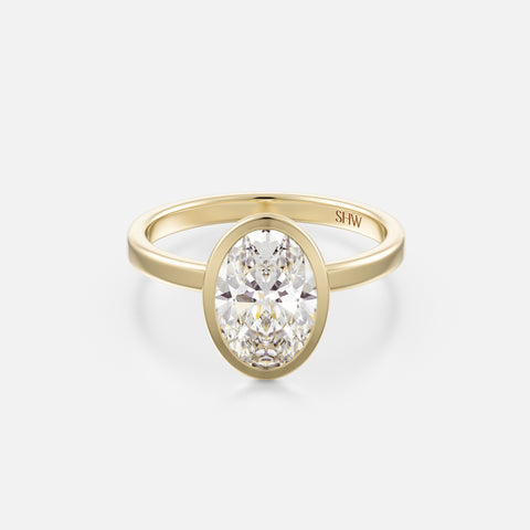 14k yellow gold thin flat band engagement ring with 2 carat north-south oval diamond in bezel setting