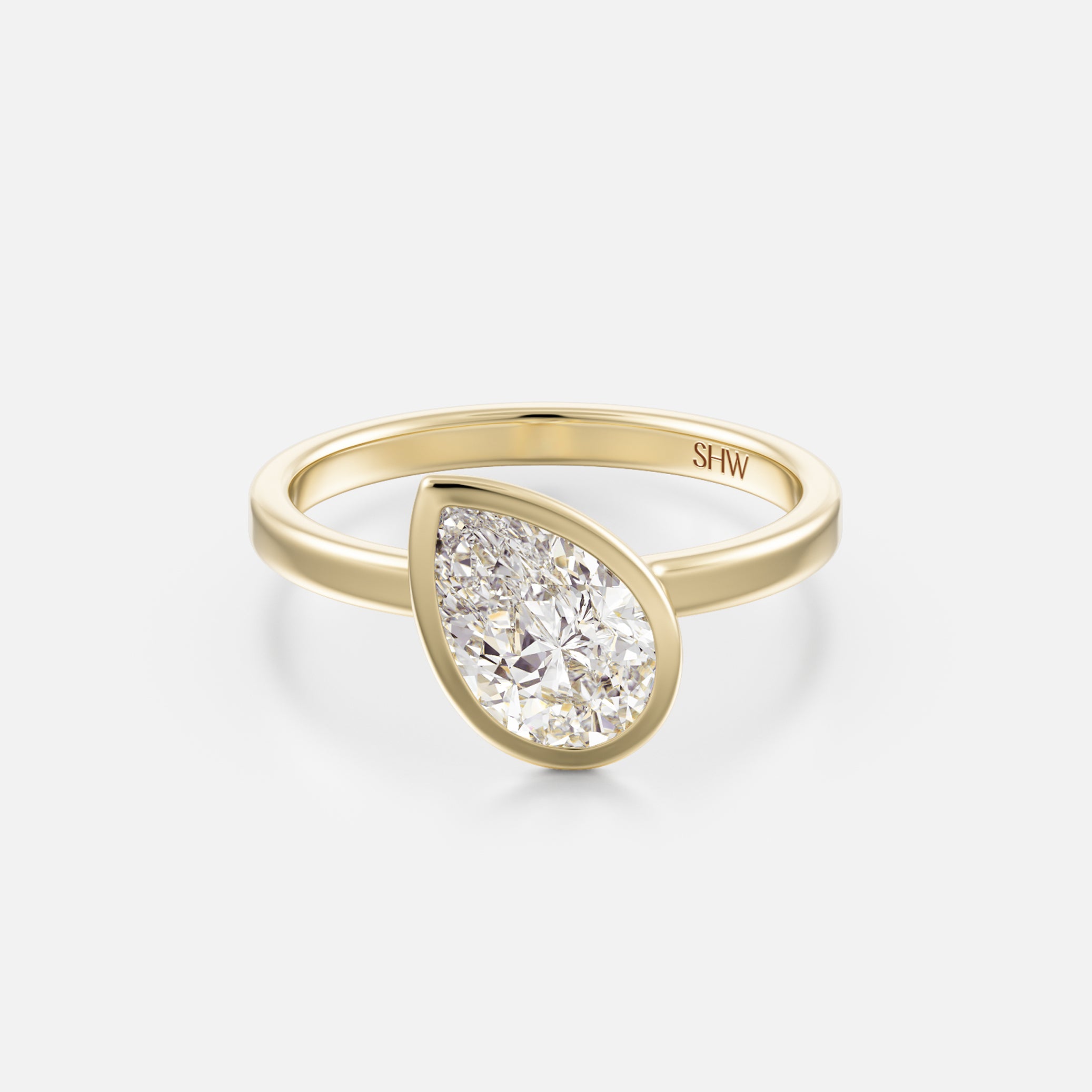 14k yellow gold thin flat band engagement ring with 1.00 carat tilted pear diamond in bezel setting