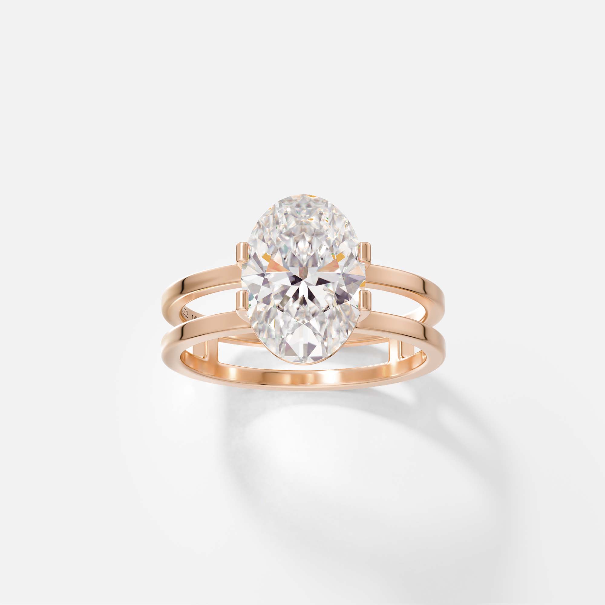 14k rose gold sculptural double band engagement ring with oval diamond