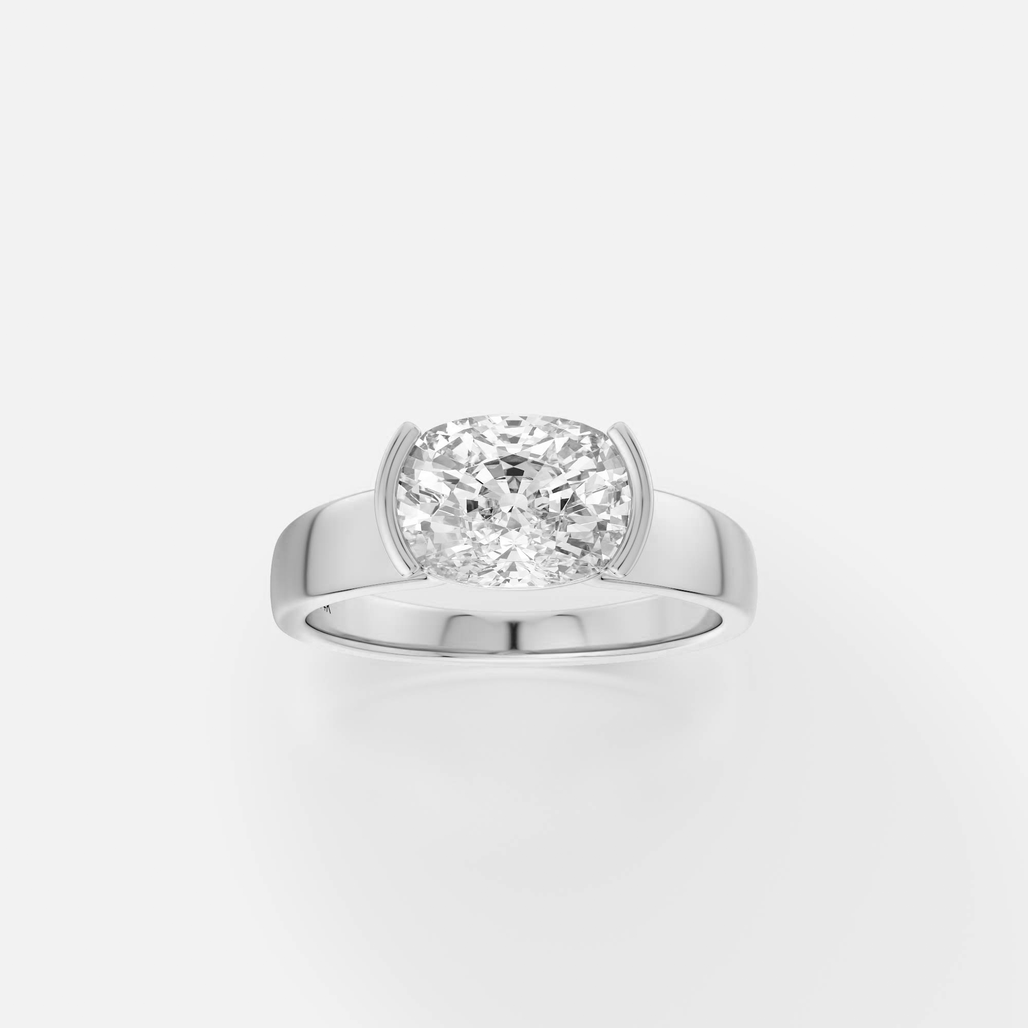 platinum engagement ring with east-west cushion diamond in tapered partial bezel on modern band