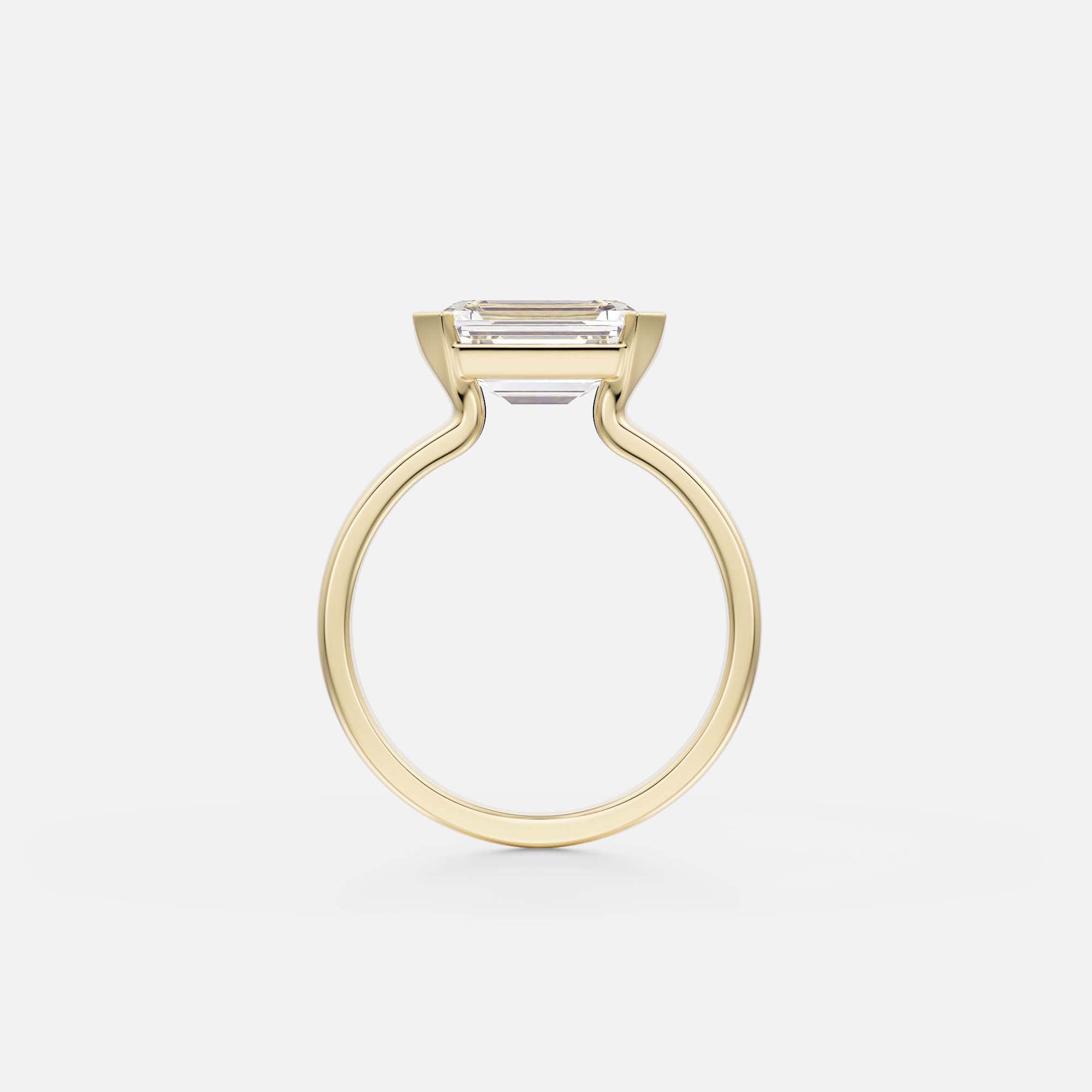 side view of east-west emerald-cut diamond engagement ring with tapering band and partial bezel open setting
