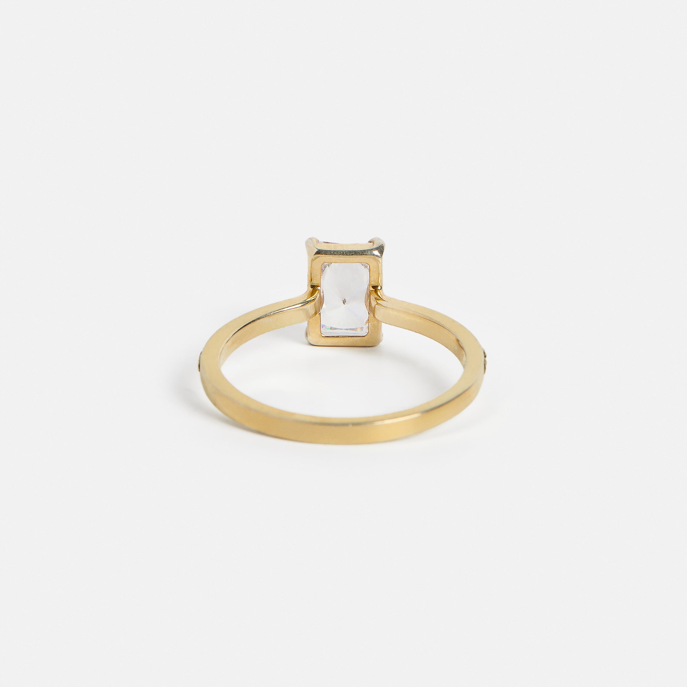 back view of 1.25 carat radiant-cut diamond engagement ring showing pavé diamond half eternity band and open setting