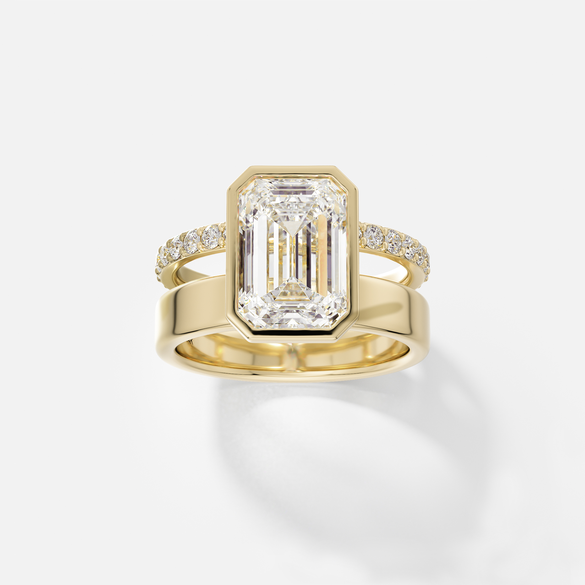 14k yellow gold engagement ring with 4.00 carat emerald-cut diamond in bezel setting and pavé diamond eternity band on double band design