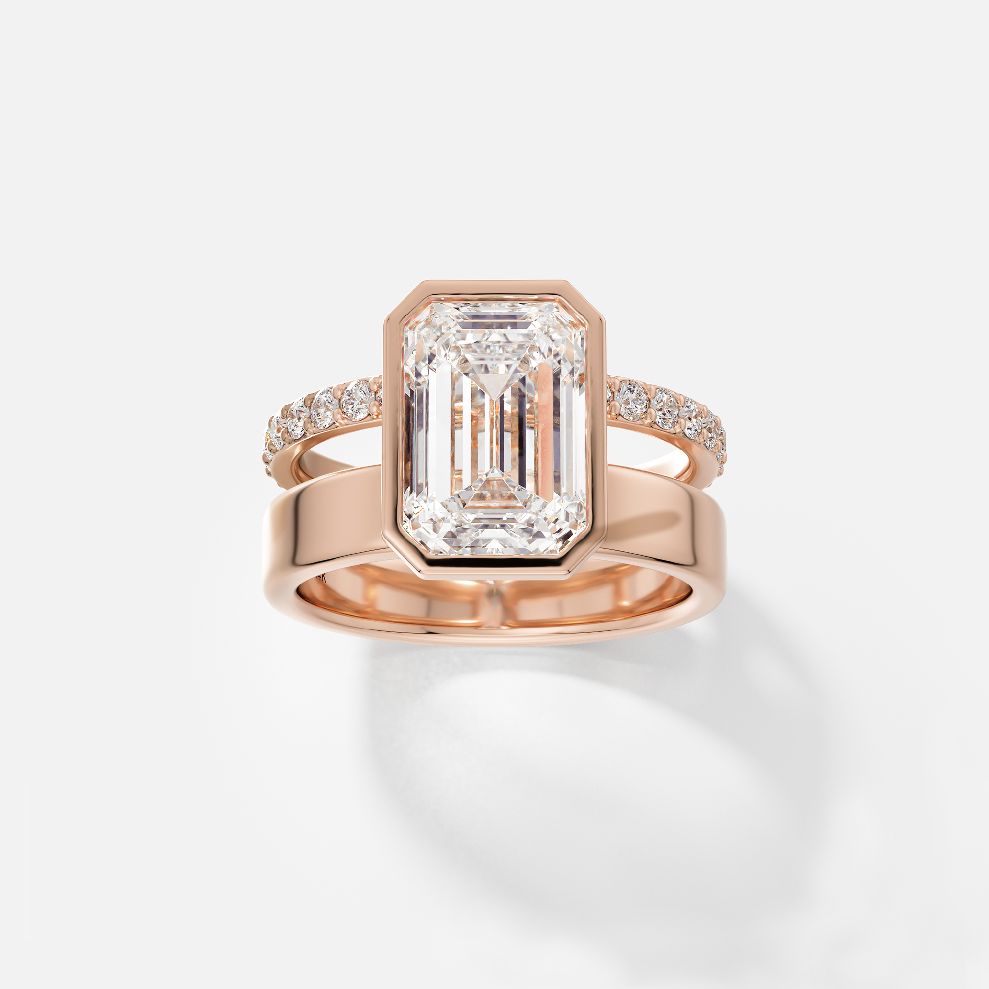14k rose gold engagement ring with 4 carat emerald cut diamond bezel setting and pavé diamond eternity band