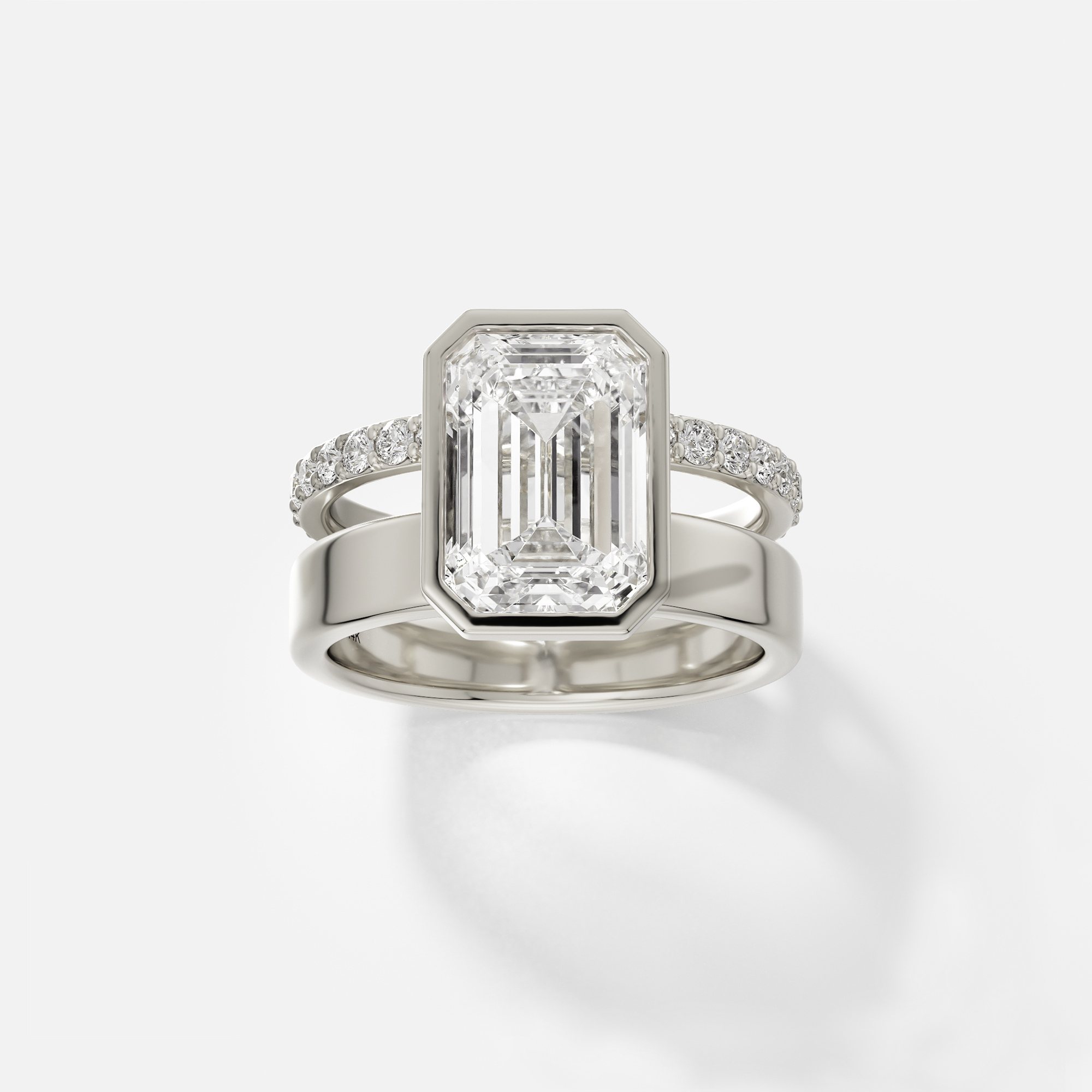 14k white gold engagement ring with 4.00 ct emerald-cut diamond bezel set with pavé diamond eternity band