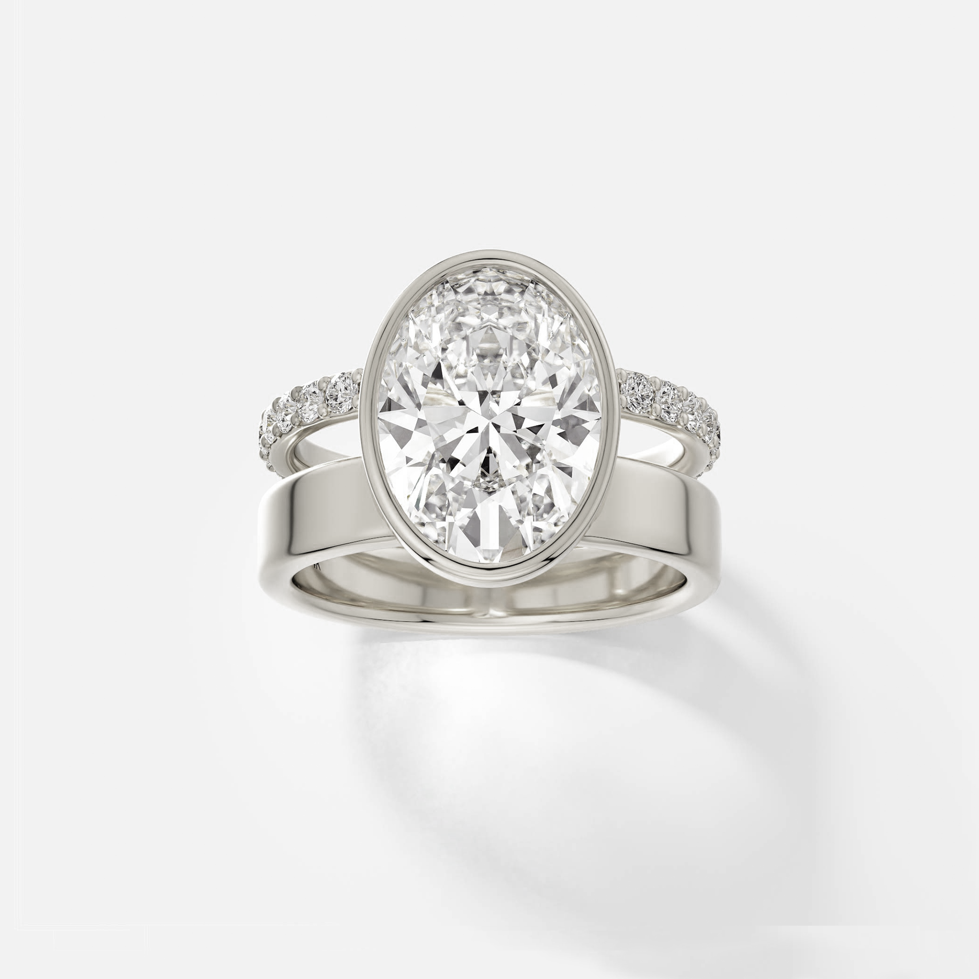 14k white gold engagement ring with 4.00 ct oval diamond bezel set with pavé diamond eternity band