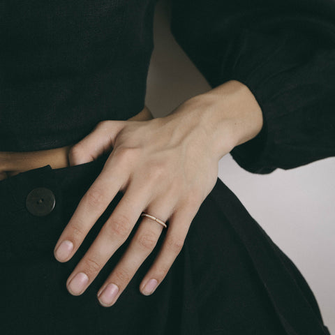 Delicate pavé diamond band shown worn in natural light