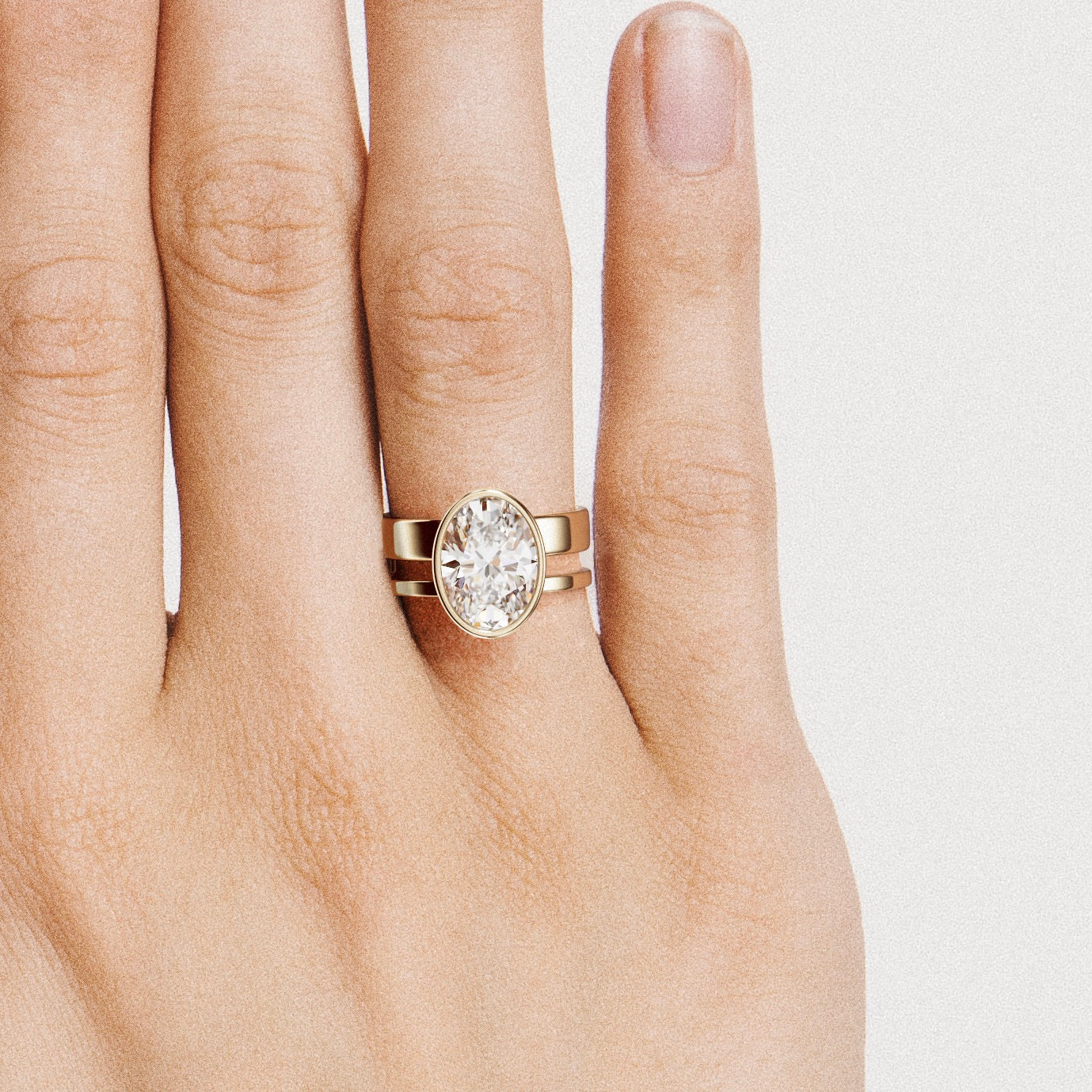 close view of 4 carat oval diamond bezel engagement ring on modern double band design
