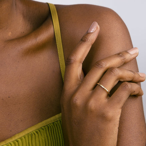 Delicate flat diamond band shown worn in natural light