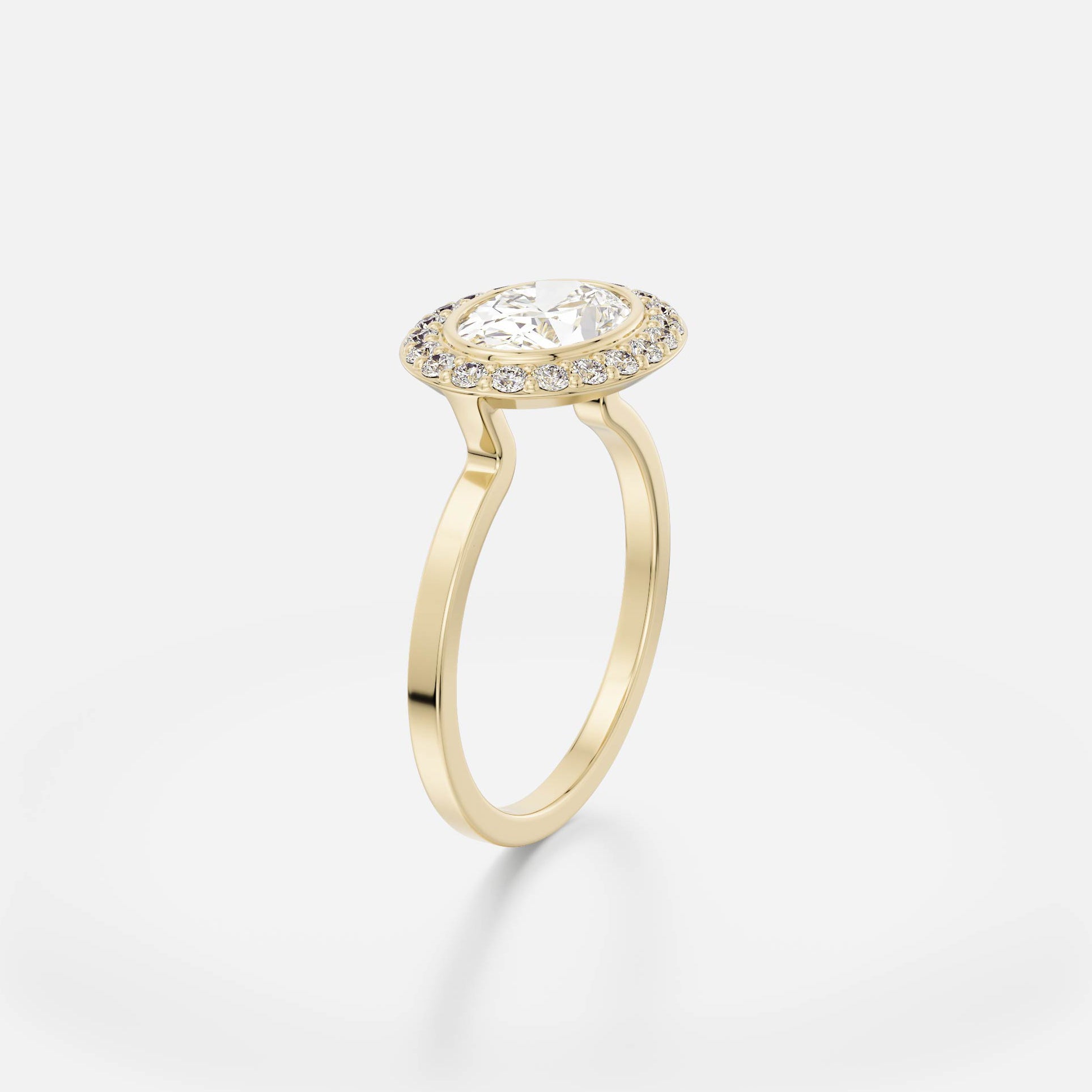 Thin flat band engagement ring with east-west oval diamond surrounded by pavé halo setting