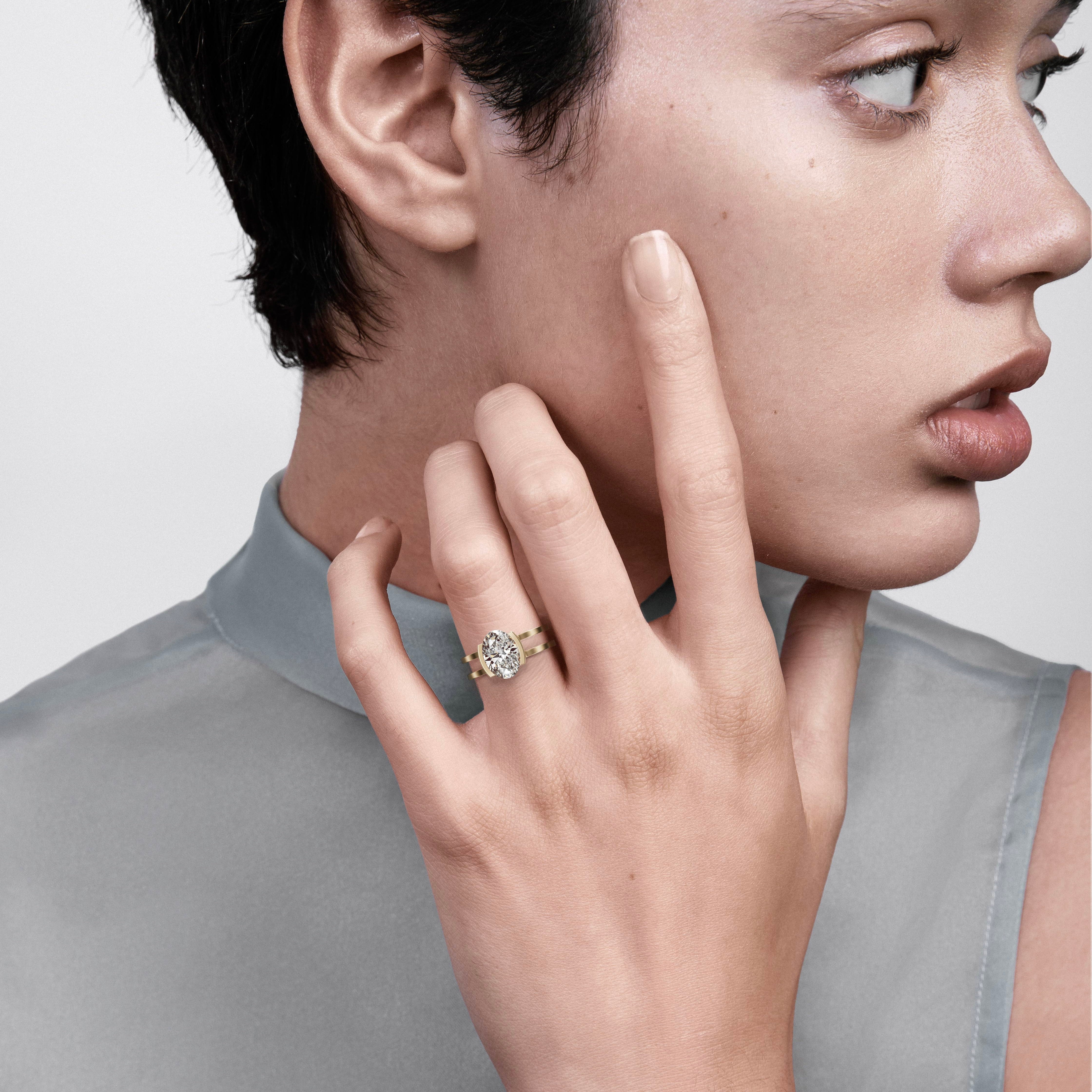 2.00 carat elongated oval diamond engagement ring with sculptural double band worn on hand