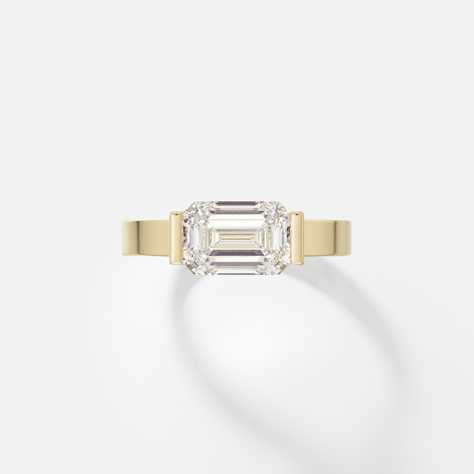 Silvi east west emerald cut diamond partial bezel engagement ring front view in 14k yellow gold