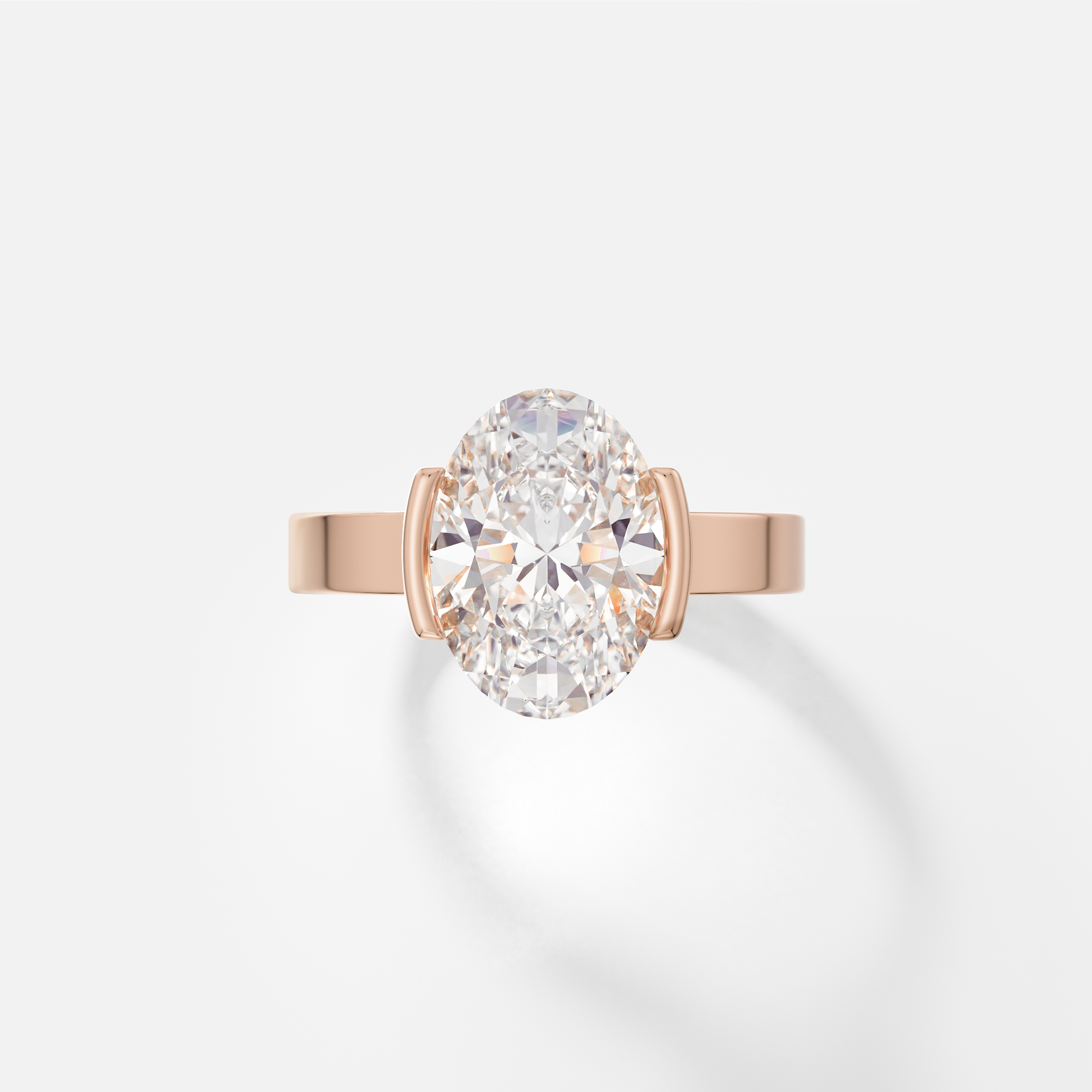 14k rose gold engagement ring with 3 carat oval diamond set in tapering partial bezel