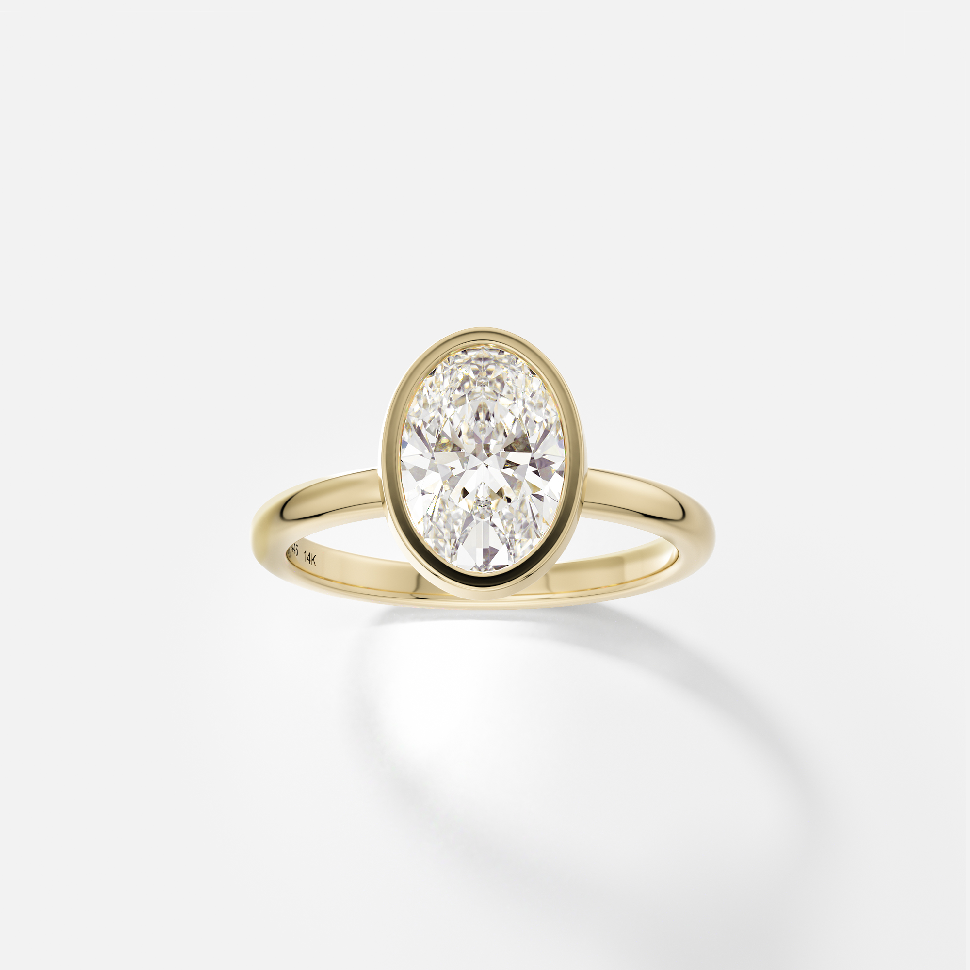 Syd oval diamond bezel engagement ring front view in 14k yellow gold