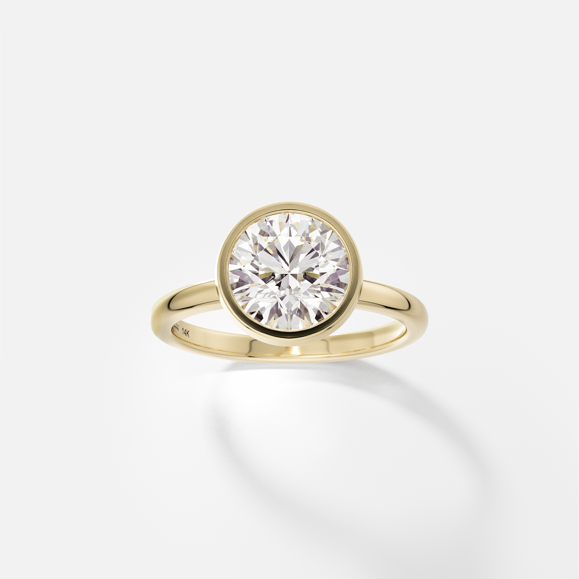 Syd round brilliant diamond thin bezel engagement ring angled side view
