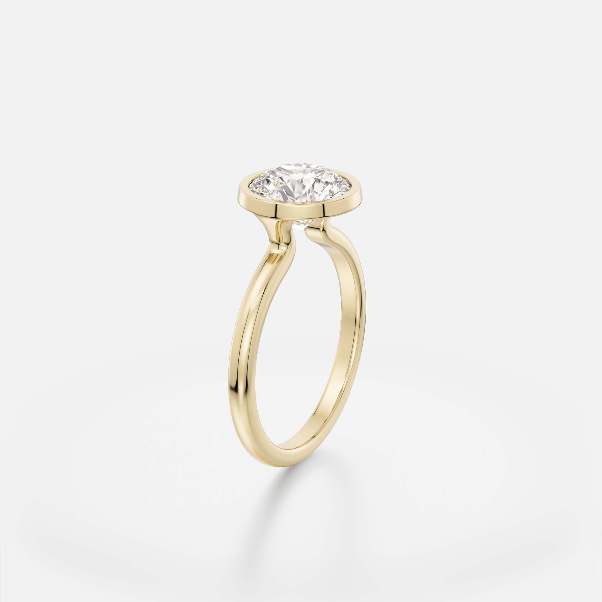 2.00 carat round brilliant diamond engagement ring with slim bezel setting and open profile on domed band