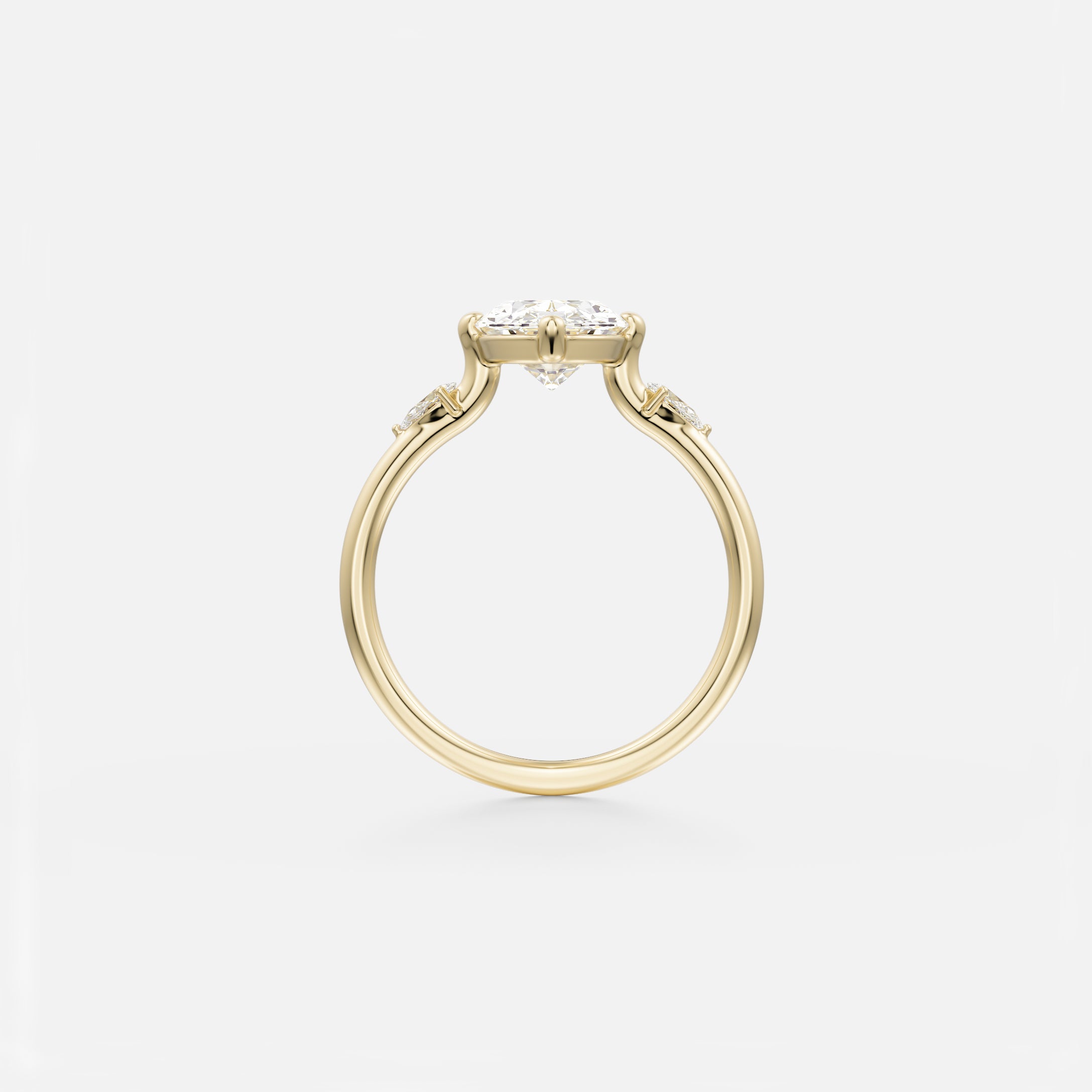 14 karat yellow gold engagement ring with oval center diamond and pear-cut side stones set into the band
