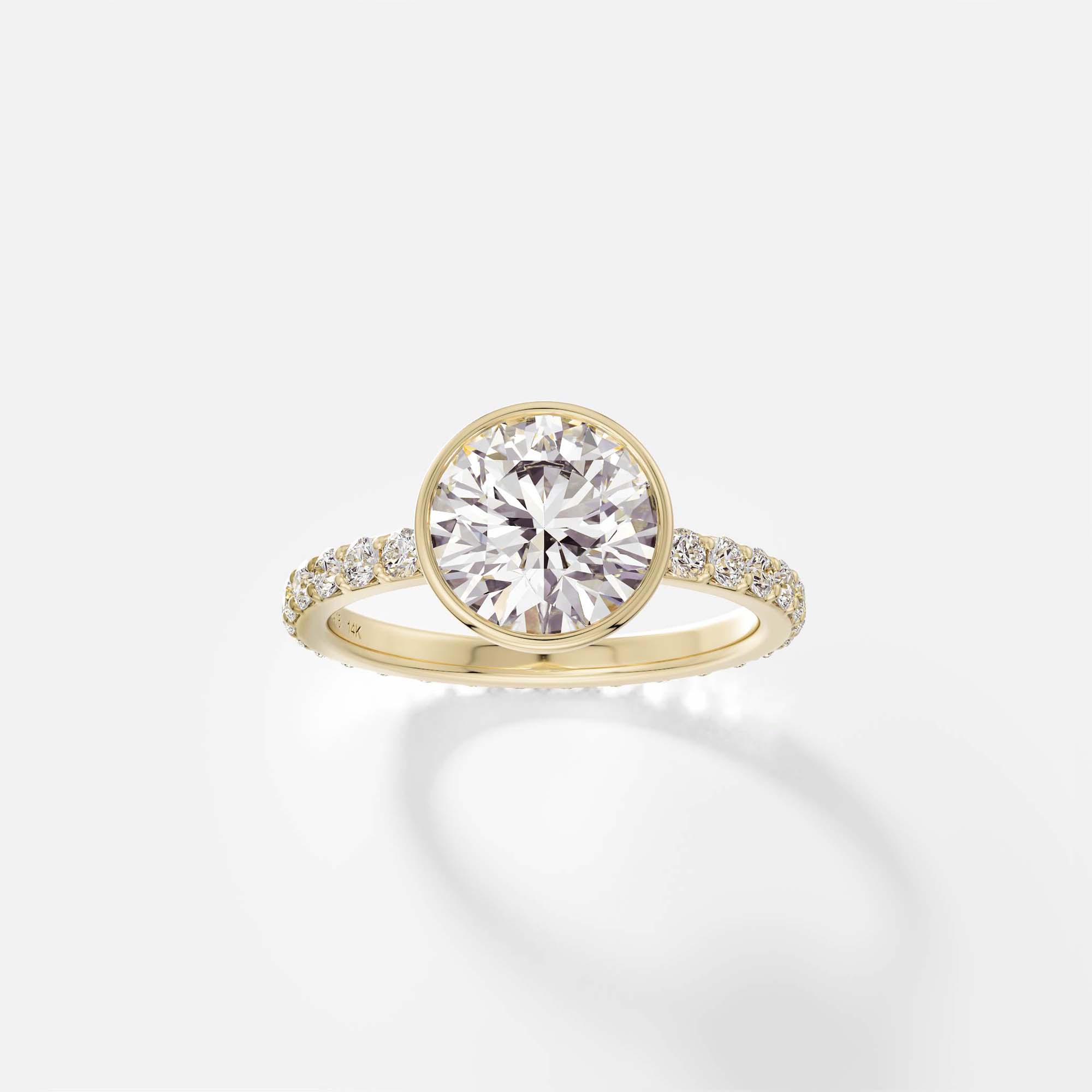 14k yellow gold engagement ring with bezel set diamond and pavé diamond half eternity band