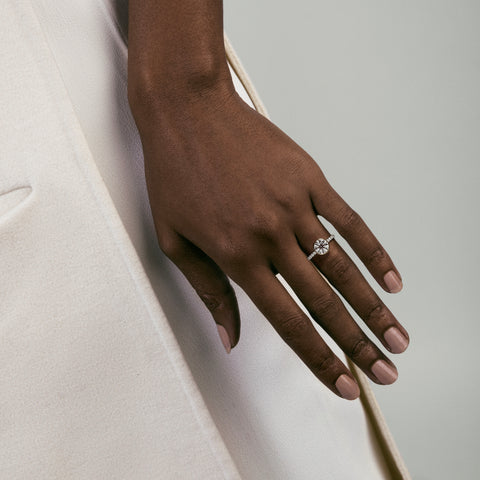 Tulpe bezel diamond pavé band engagement ring worn on hand
