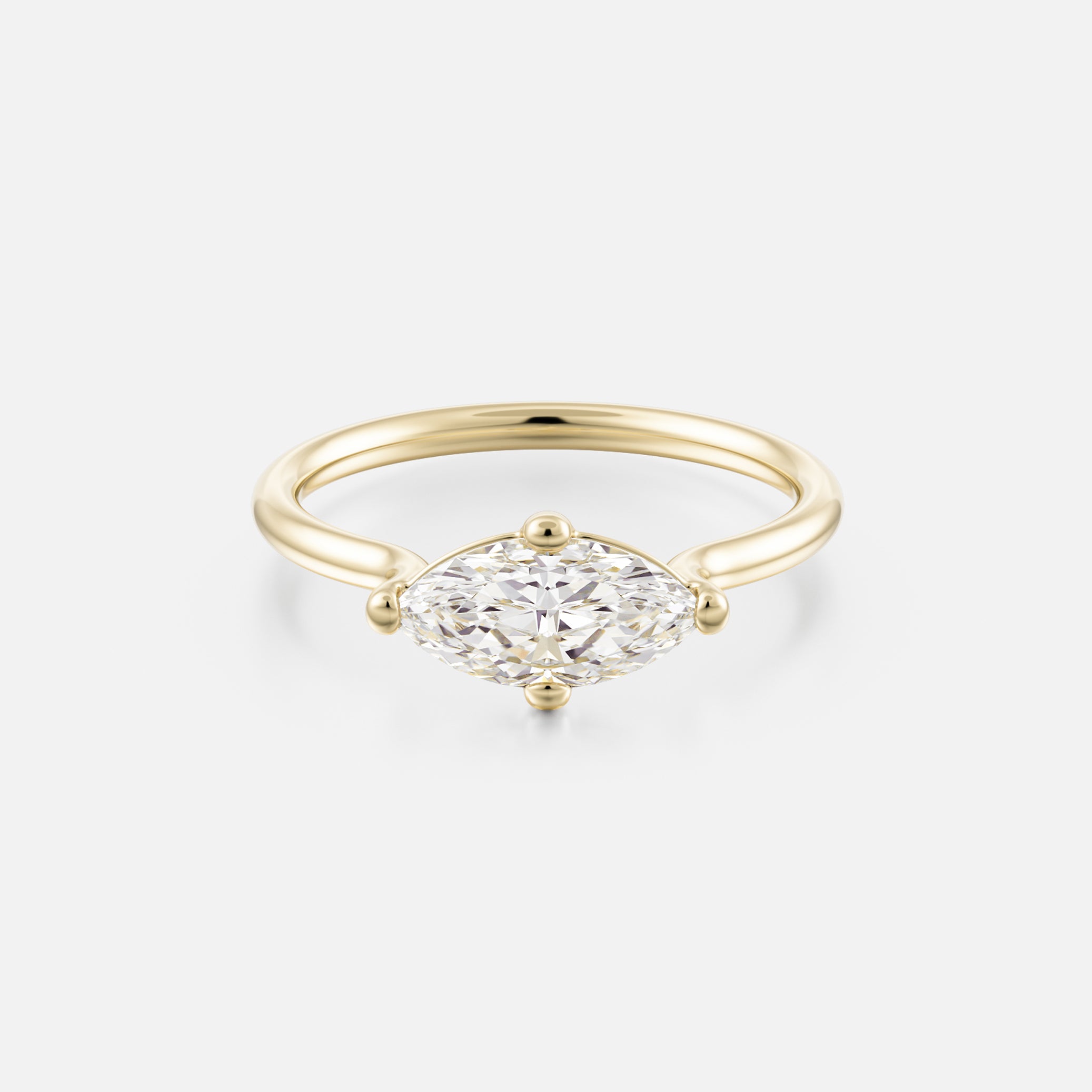 14k yellow gold engagement ring with 1 carat east-west marquise diamond on thin round profile band with compass prongs