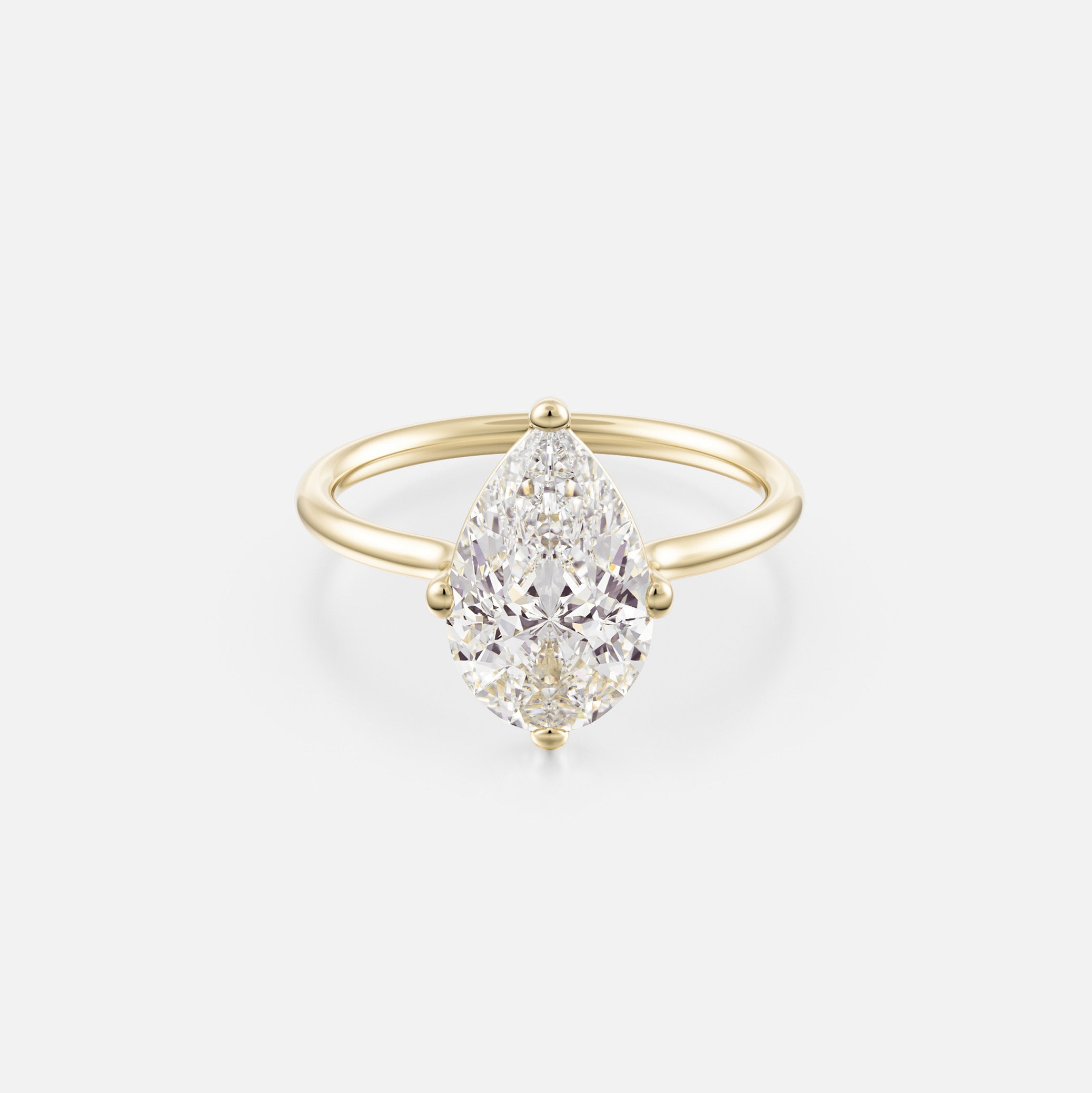 14k yellow gold engagement ring with 3 carat pear-shaped diamond set north south on thin round profile band