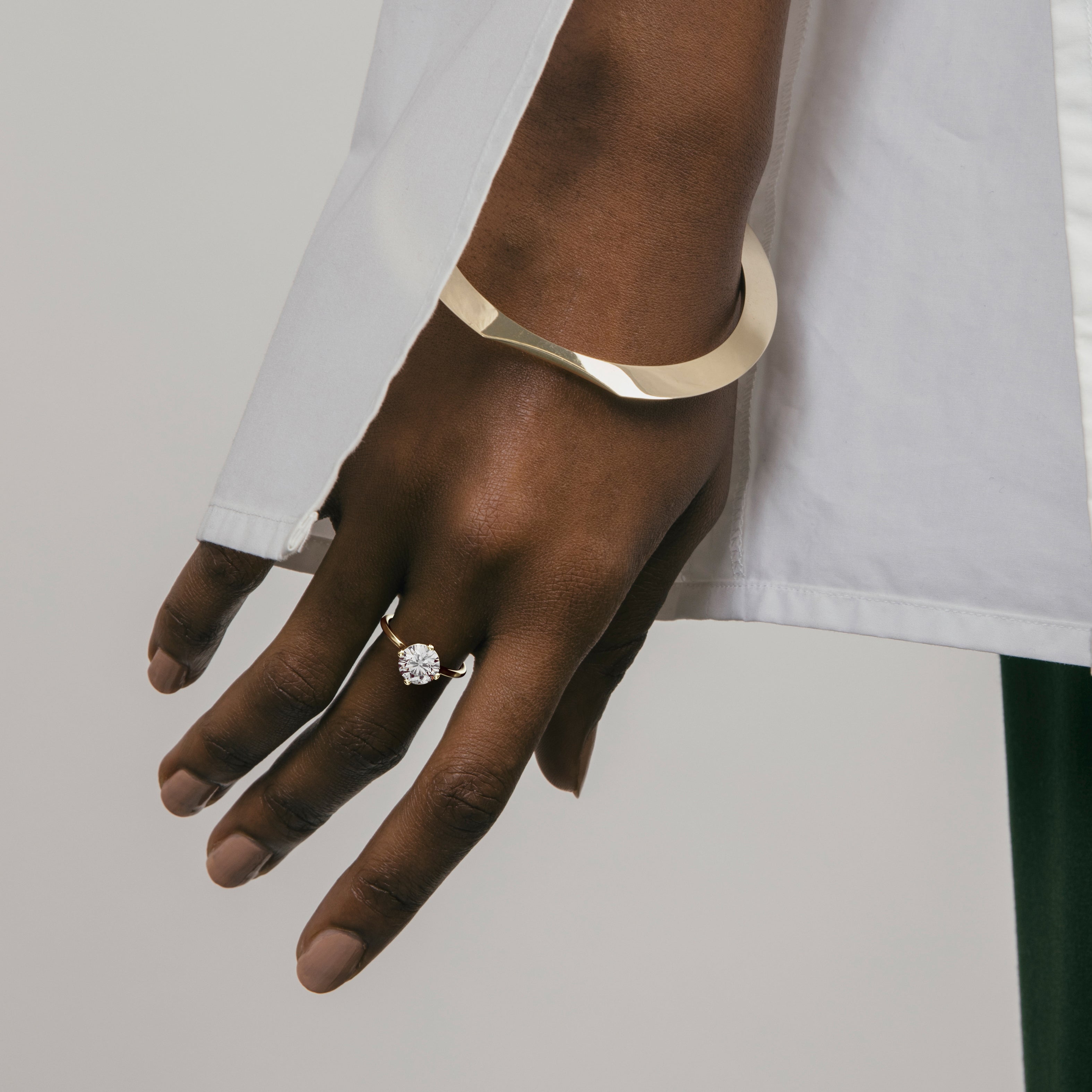 14k yellow gold engagement ring with 2.00 ct round brilliant diamond worn on hand