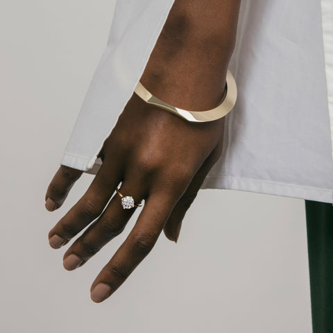 14k yellow gold engagement ring with 2.00 ct round brilliant diamond worn on hand