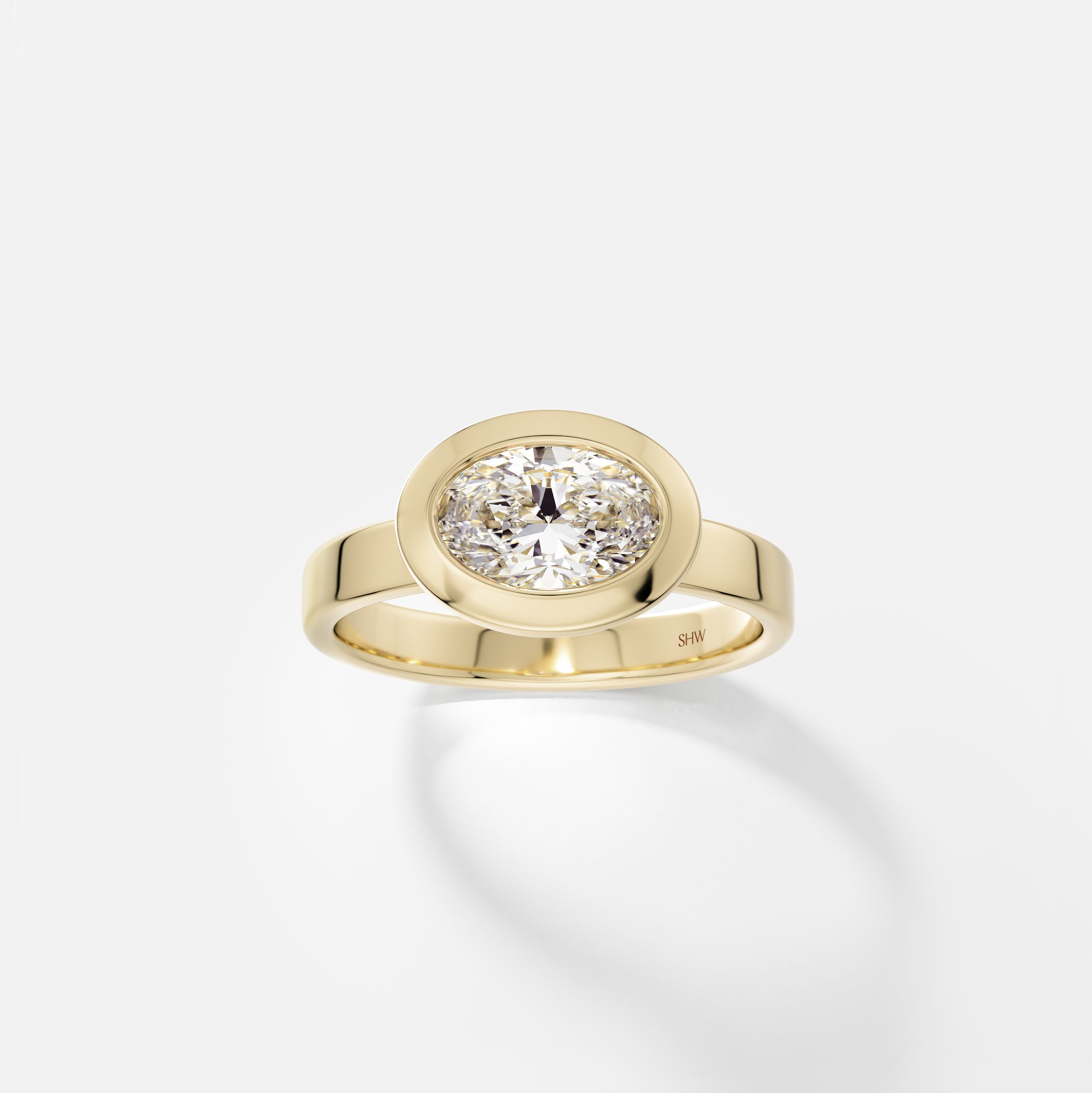 14k yellow gold wide flat band engagement ring with 1 carat east-west oval diamond in thick bezel setting