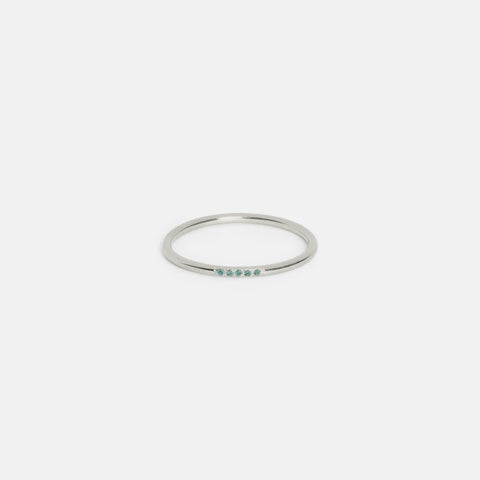 14k white gold slim round band with five emerald gemstones